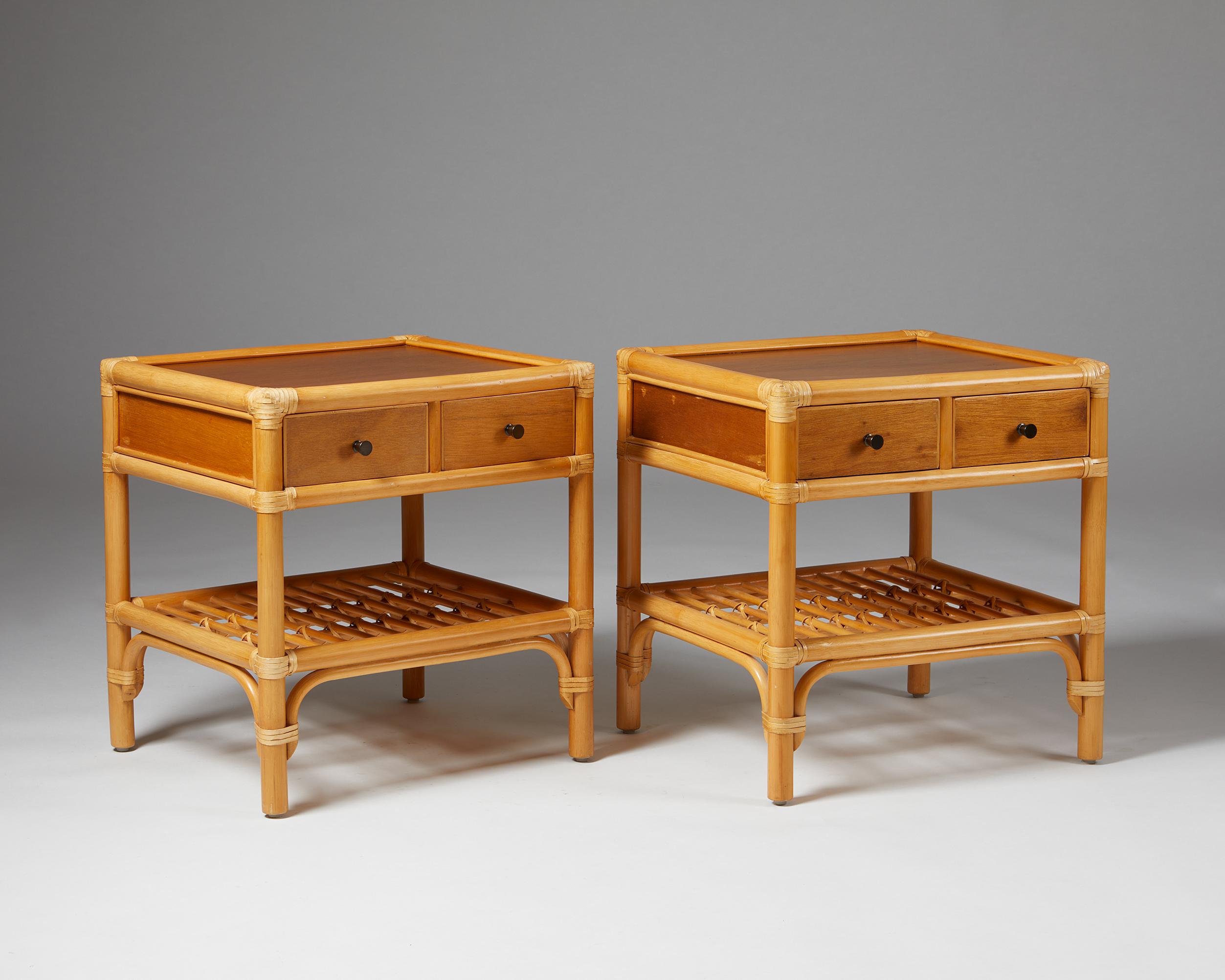 Pair of bedside tables, anonymous for DUX,
Sweden. 1960s.
Cane, rattan and teak.

The colonial-style combination of cane, rattan, and teak makes this Scandinavian bedside table design particularly interesting. The woven edges and metal handles