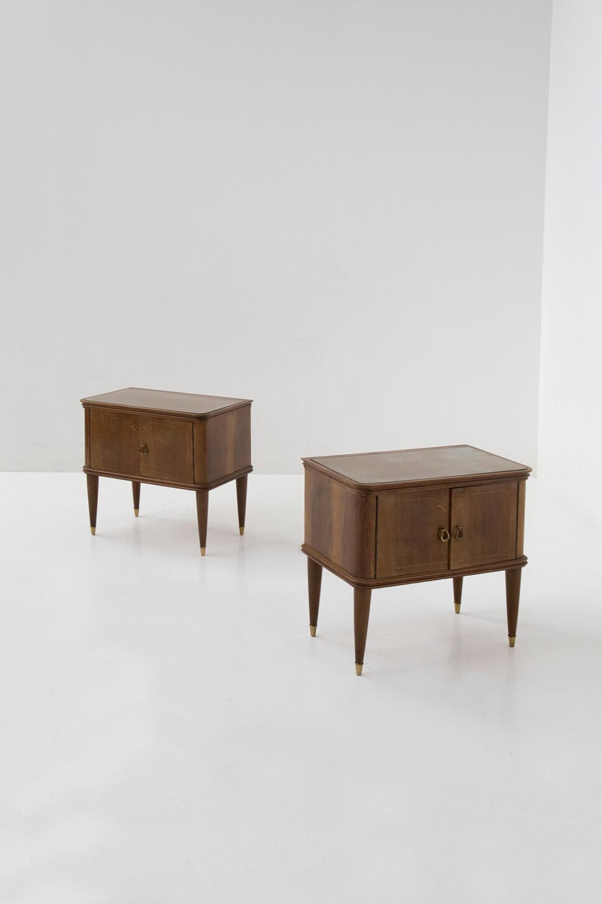 Pair of bedside tables attributed to Paolo Buffa from the Italian 1950s. The pair features an elegant and understated wooden frame with small designs on the wood as a decorative element. The nightstands open via two doors that can be opened by two