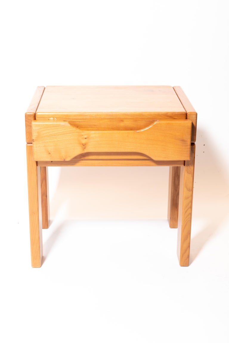 Pair of bedside tables, Edition Prestige Ameublement, France, c. 1980s. 

Attractive design consists of a solid elm construction, plank legs, and handsome cut-out drawer handles. Excellent vintage condition.