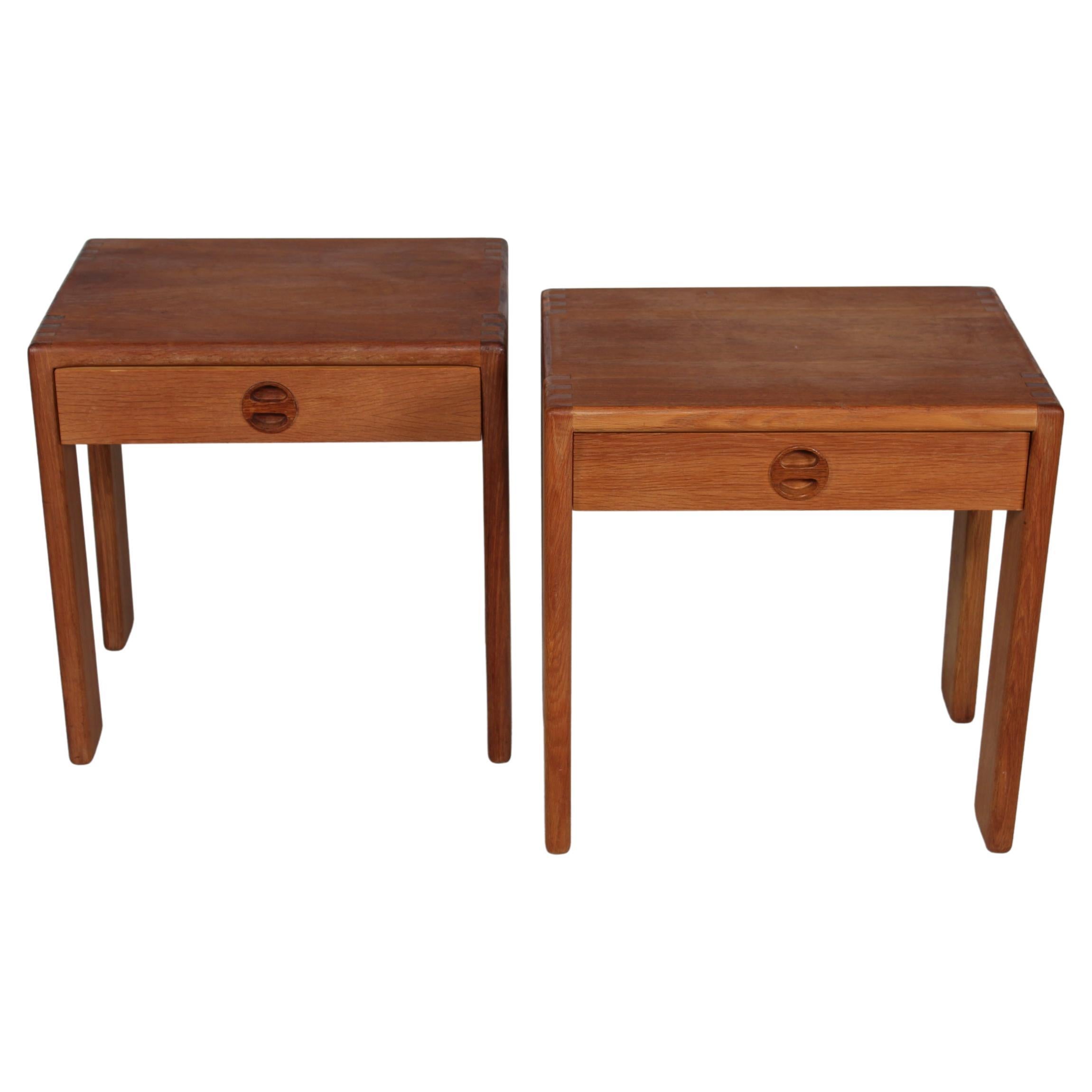 Mid-Century Modern pair of nightstands by Finnish designer Esko Pajamies for Asko Finland. Made circa 1960s to 1970s.

The nightstands are not identical but very similar.

They are partly made from solid oak and parts with oak veneer. The decorative