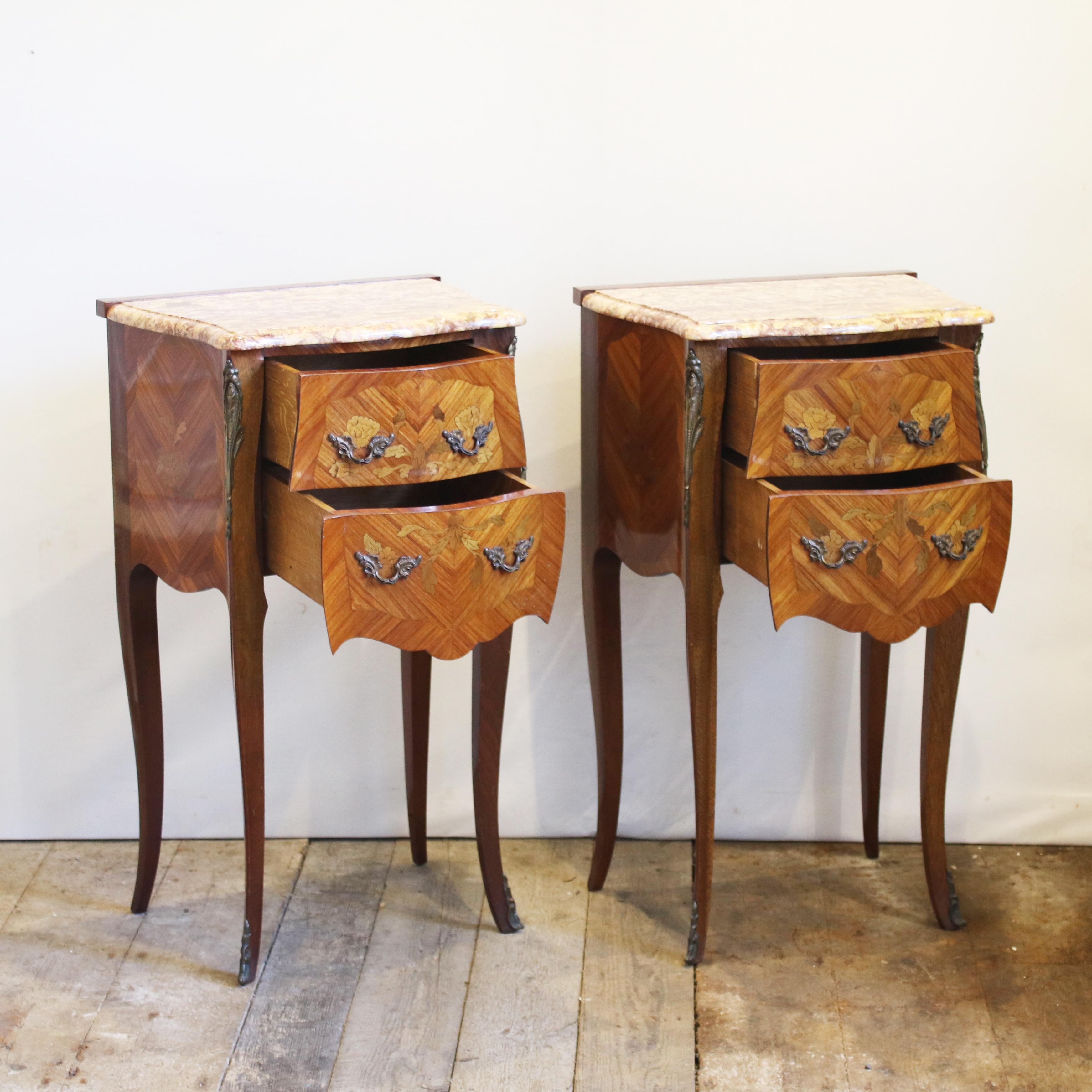 An elegant pair of matching bedside tables with marble tops. These bedside tables have two working drawers and are finished with decorative fruitwood inlay work. These bedside table are part of a set with code D1 and code D2 in our 'other furniture'