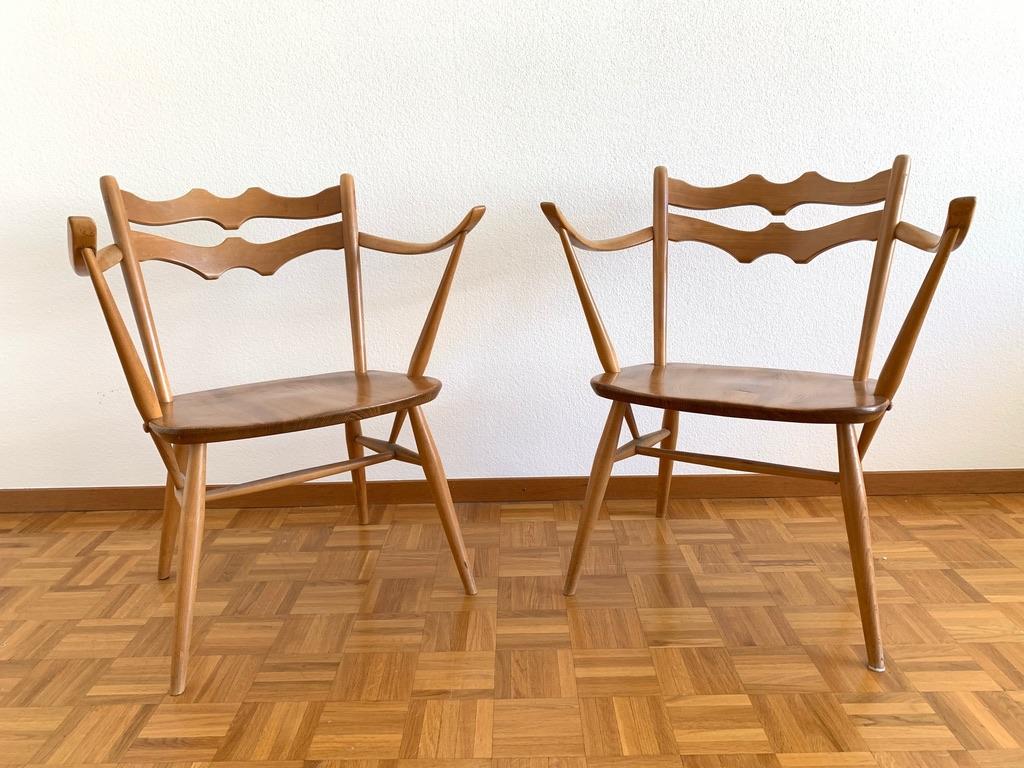 Pair of elm and beech easy chairs model 493 produced by Ercol, England circa 1950s.
Ercol is the name of a British furniture manufacturer. The firm dates back to 1920, when it was established in  Buckinghamshire, as Furniture Industries by Lucian