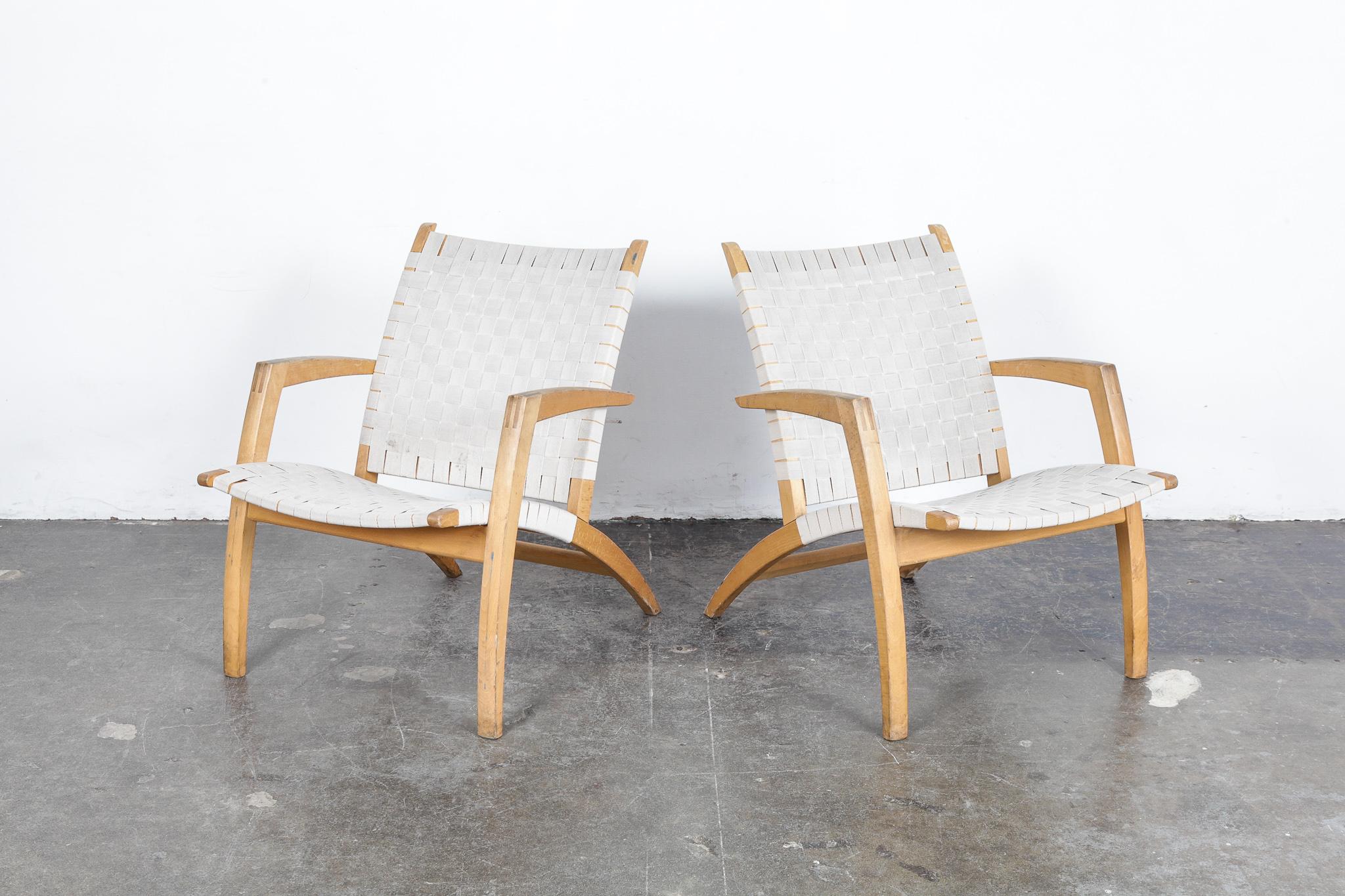 Pair of beechwood frame lounge chairs with exposed finger joinery on each arm, with original strapping, designed by Bill Potter for Vejle Mobelfabrik, Denmark, 1960s.