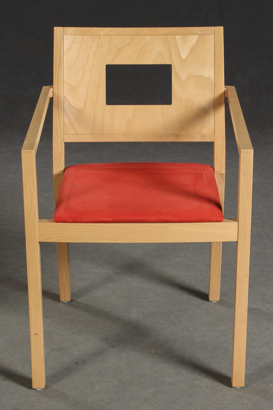 Pair of upholstered stacking chairs by Brunner.
Laminated beech wood frame, with armrests. Various upholstery fabrics, one in red, one in black.