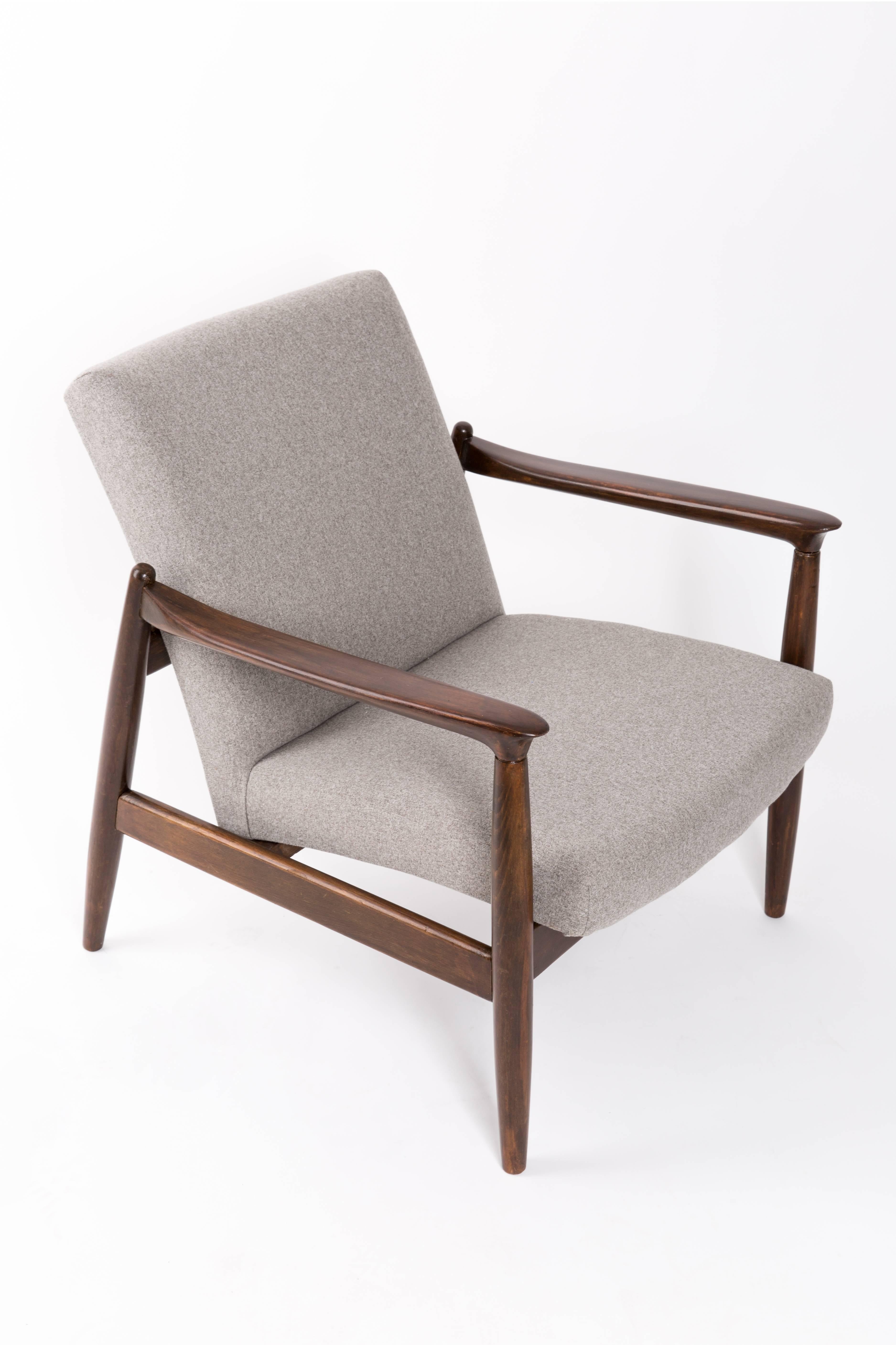 A pair of beige armchairs, designed by Edmund Homa. The armchairs were made in the 1960s in the Gosciecinska Furniture Factory. They are made from solid beechwood. The GFM type armchair is regarded one of the best Polish armchair design from the
