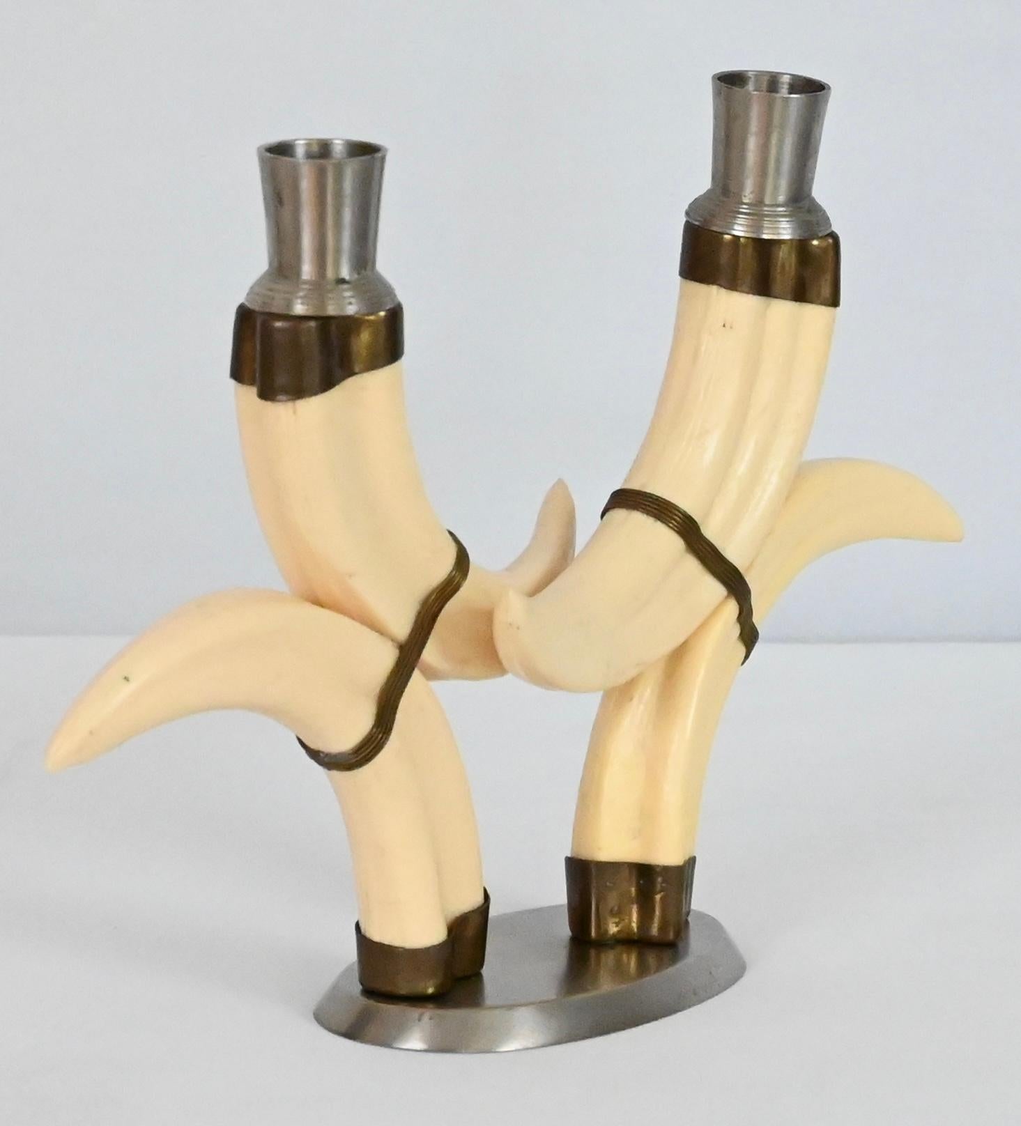A stunning pair of beige faux horn candlesticks, brass decorations and nickel plated tips, circa 1970. 

These stylishly design candlesticks would enhance any table, counter, console, credenza in a variety of interiors.

Very good original
