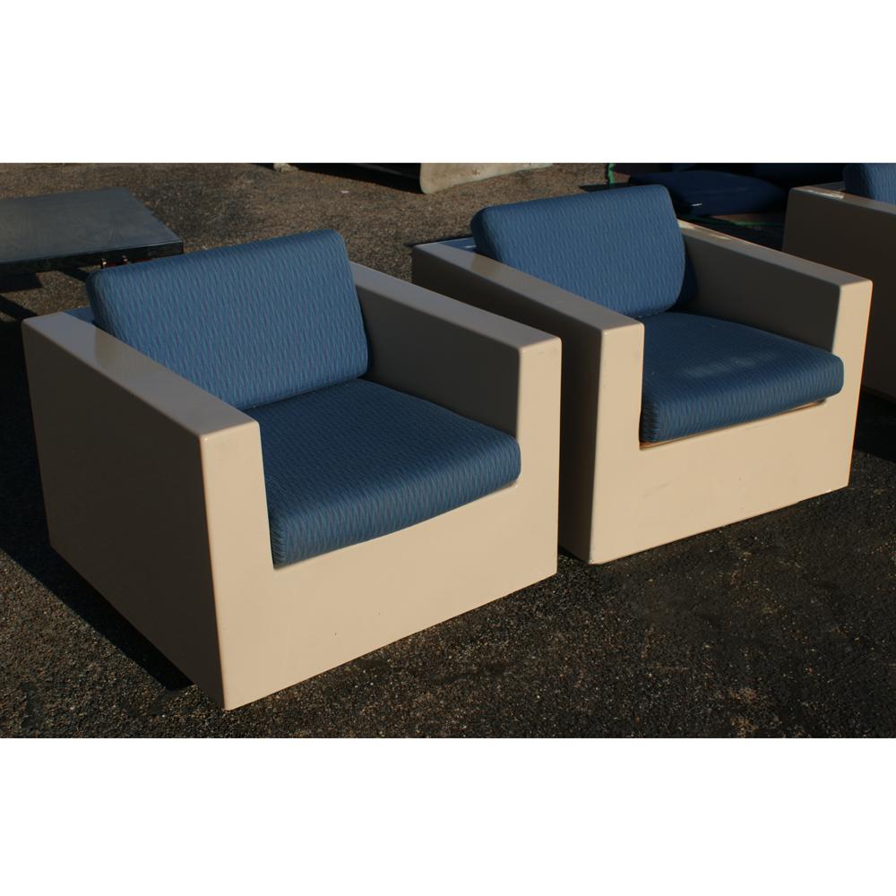 A Mid-Century Modern pair of beige fiberglass lounge chairs with dark blue cushions. As shown in the last image, we have other similar fiberglass pieces listed on 1stdibs.