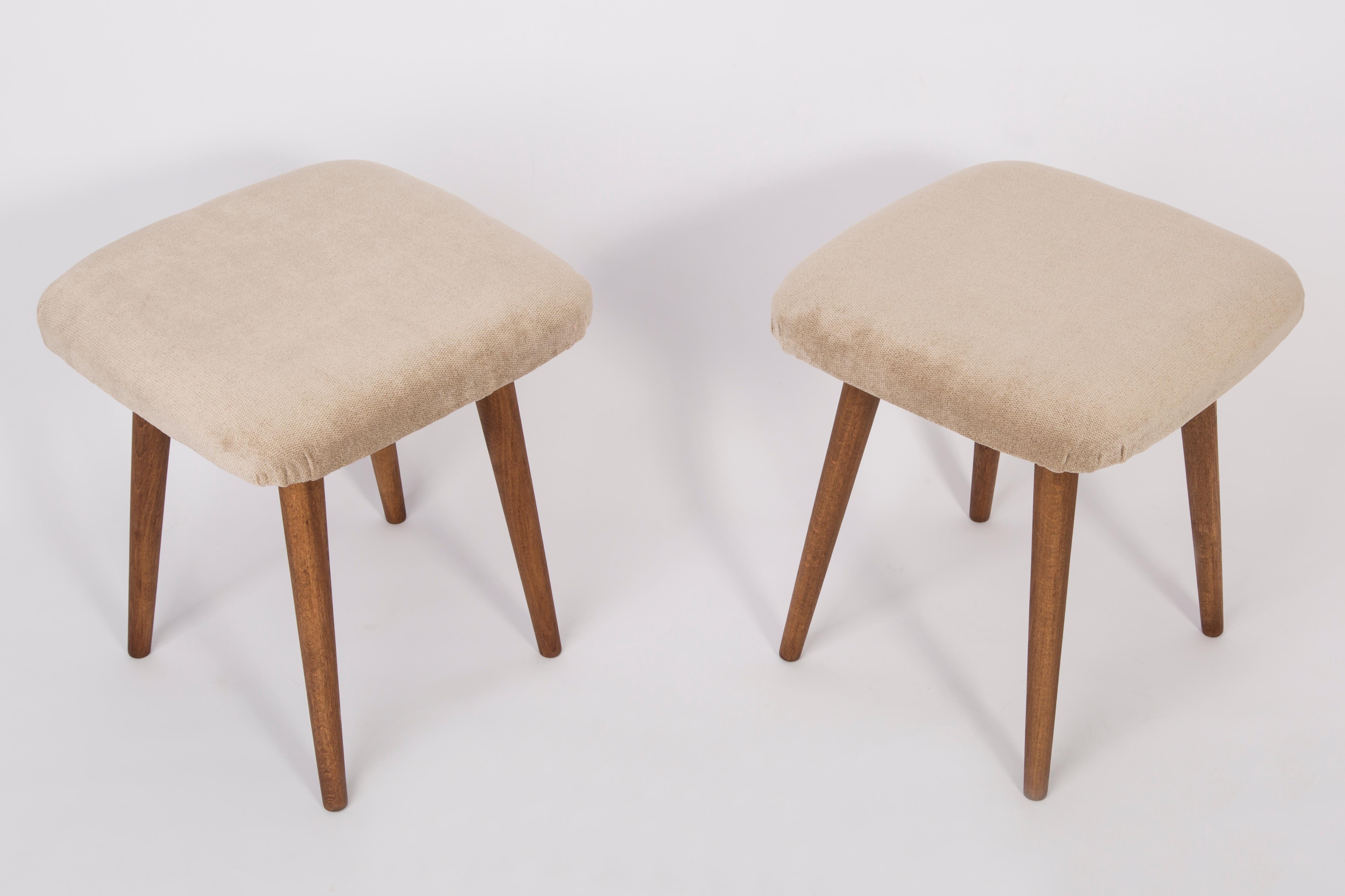 Stool from the turn of the 1960s and 1970s. Beautiful, well crafted beige upholstery. The stool consists of an upholstered part, a seat and wooden legs narrowing downwards, characteristic of the 1960s style. We can prepare this pair also in another