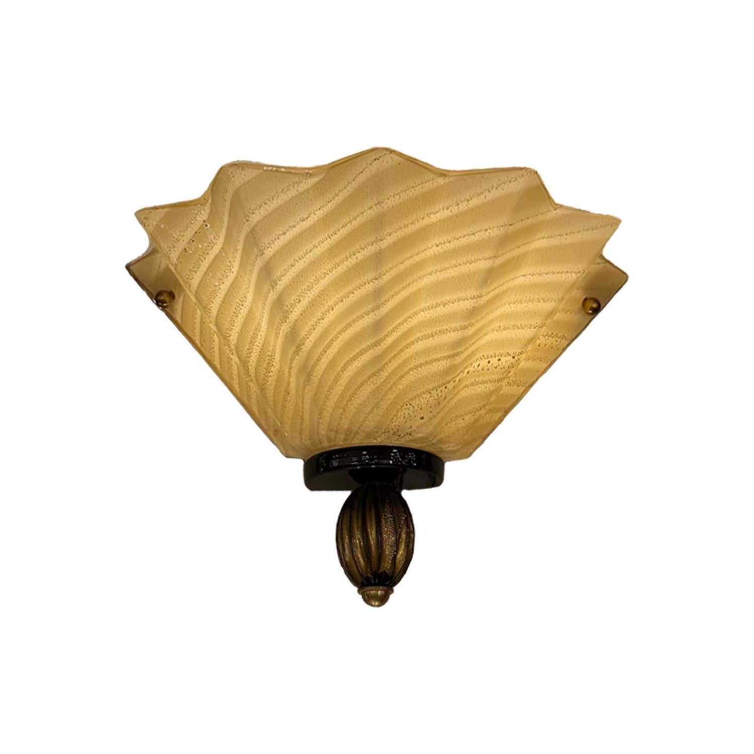 Classic elegance meets artisanal craftsmanship in this stunning pair of beige Venetian sconces. Each sconce features a softly scalloped fan-shaped shade in warm beige Murano glass, delicately striped with subtle texture and natural variation.

The