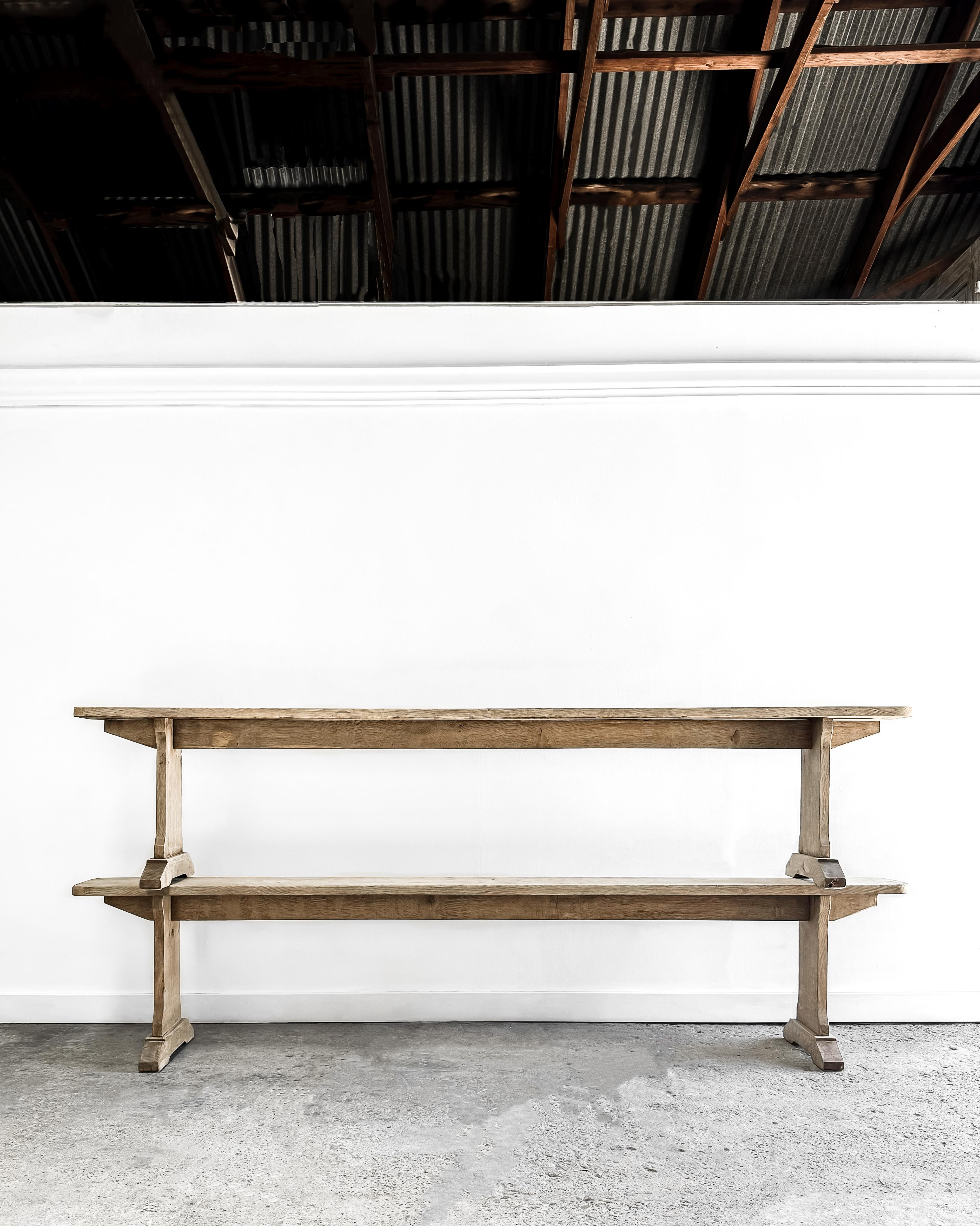 Add a touch of vintage charm to your modern home with this delightful pair of antique oak benches. Each bench is meticulously crafted, featuring a rounded end seat seamlessly joined to the legs with traditional pegged joinery. The elegantly shaped