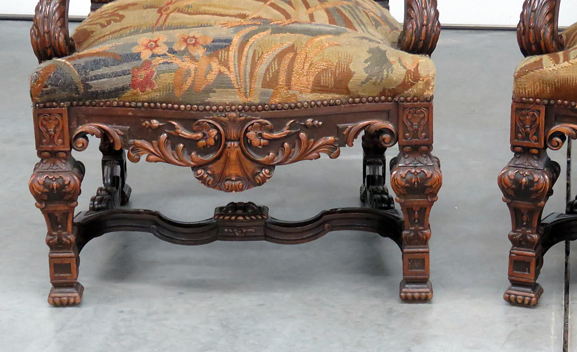 Pair of Belgian Renaissance style needlepoint armchairs with nailhead trim.