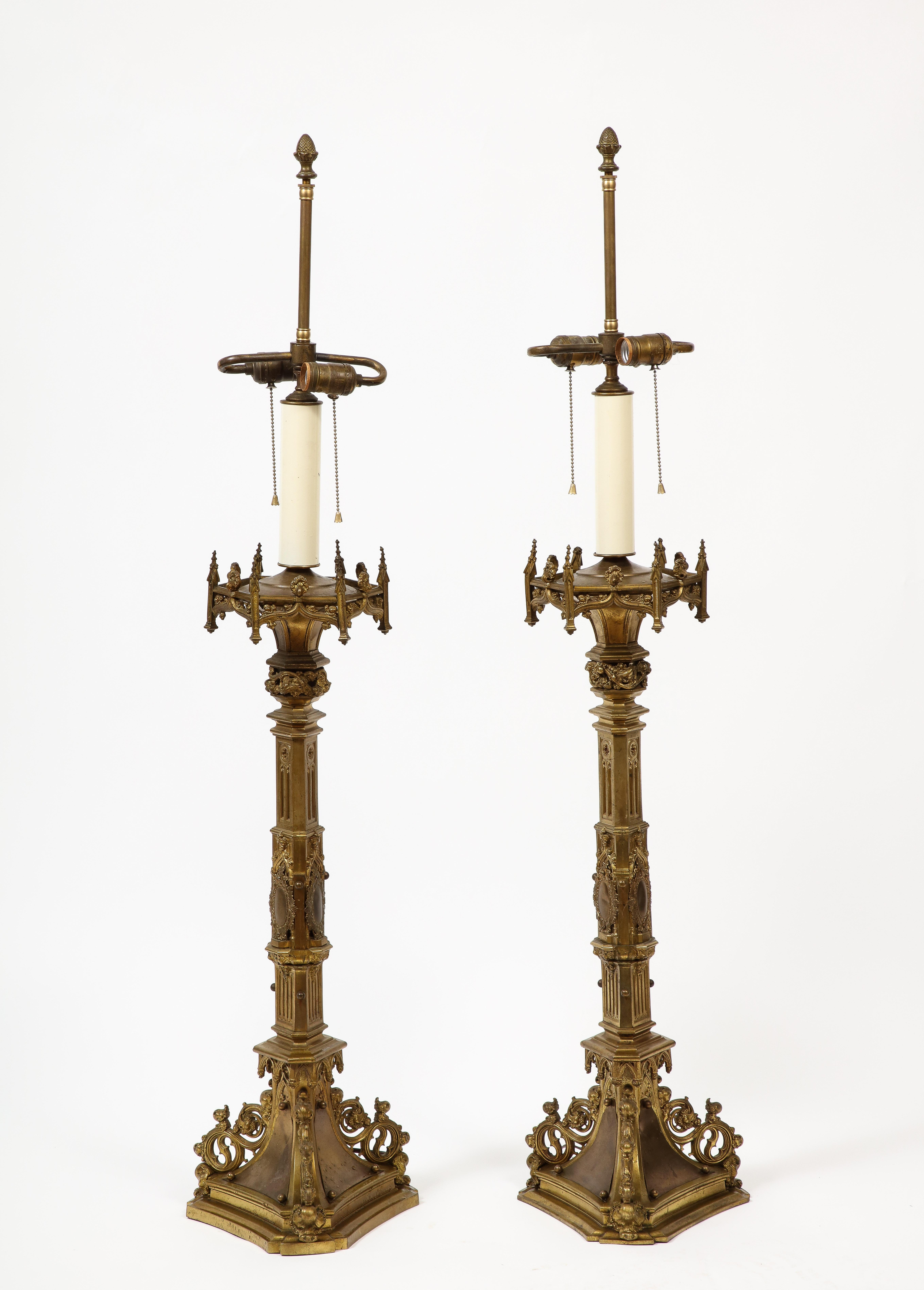 Pair of ornate Rococo style gilt metal table lamps, 20th century Belgian. Two sockets per lamp with pull chain for each socket. 

Additional dimensions:
upper hexagon 8