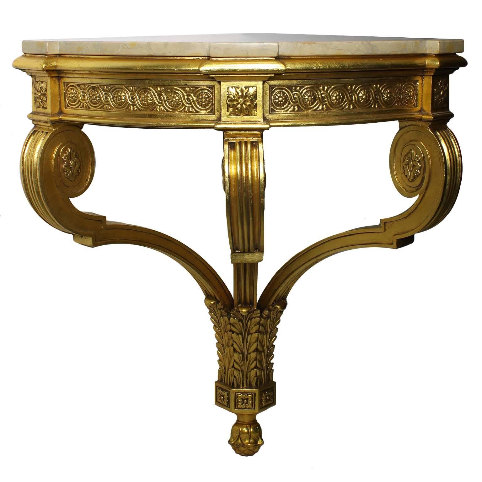 A pair of French Belle Époque 19th-20th century Louis XV style giltwood carved wall mounting corner-console tables with marble top. The tripod leg consoles with scrolled supports and an acanthus base with rosette and token decorations. The mottled