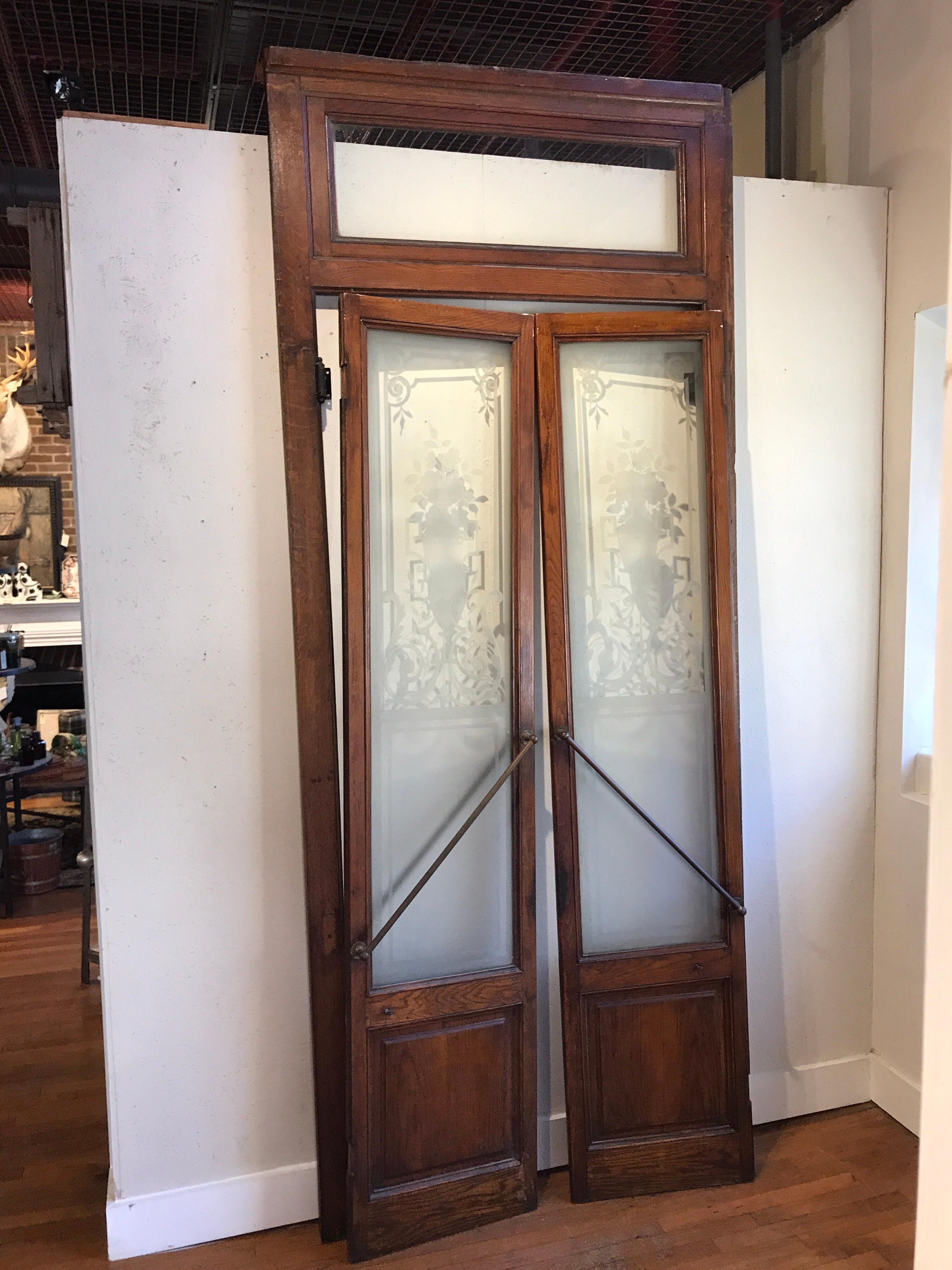 Pair of Belle époque French acid etched Bistro Doors & Transom, Paris 1890-1910
Consisting of a the door frame and two acid etched floral glass doors with original brass and iron handles
The frame measures 117