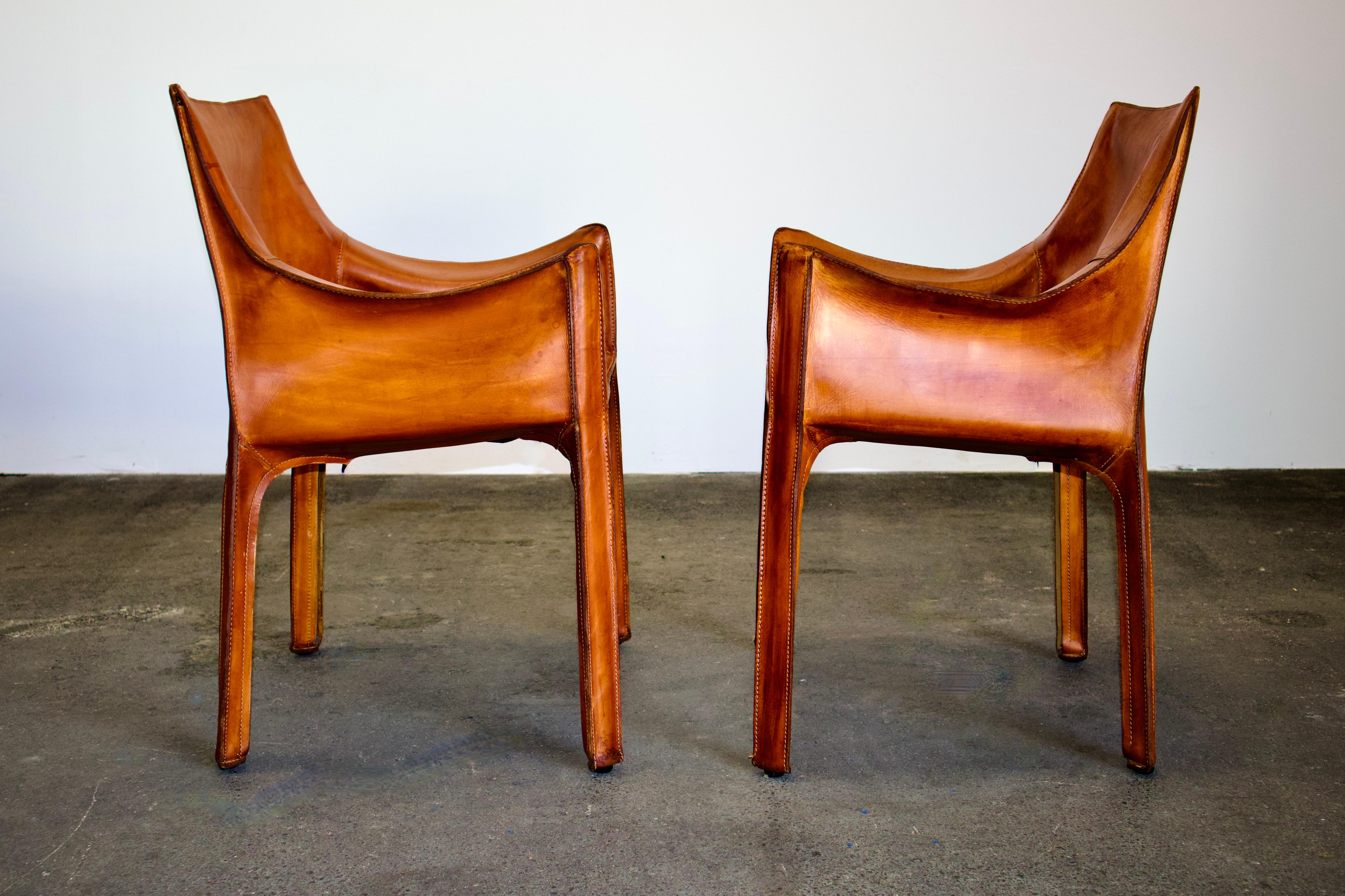 Exquisite pair of original Mario Bellini CAB 413 chairs, a true emblem of timeless design. Manufactured by the renowned Italian design house, Cassina, in the 1970s, these chairs represent a perfect amalgamation of form and function.

Key