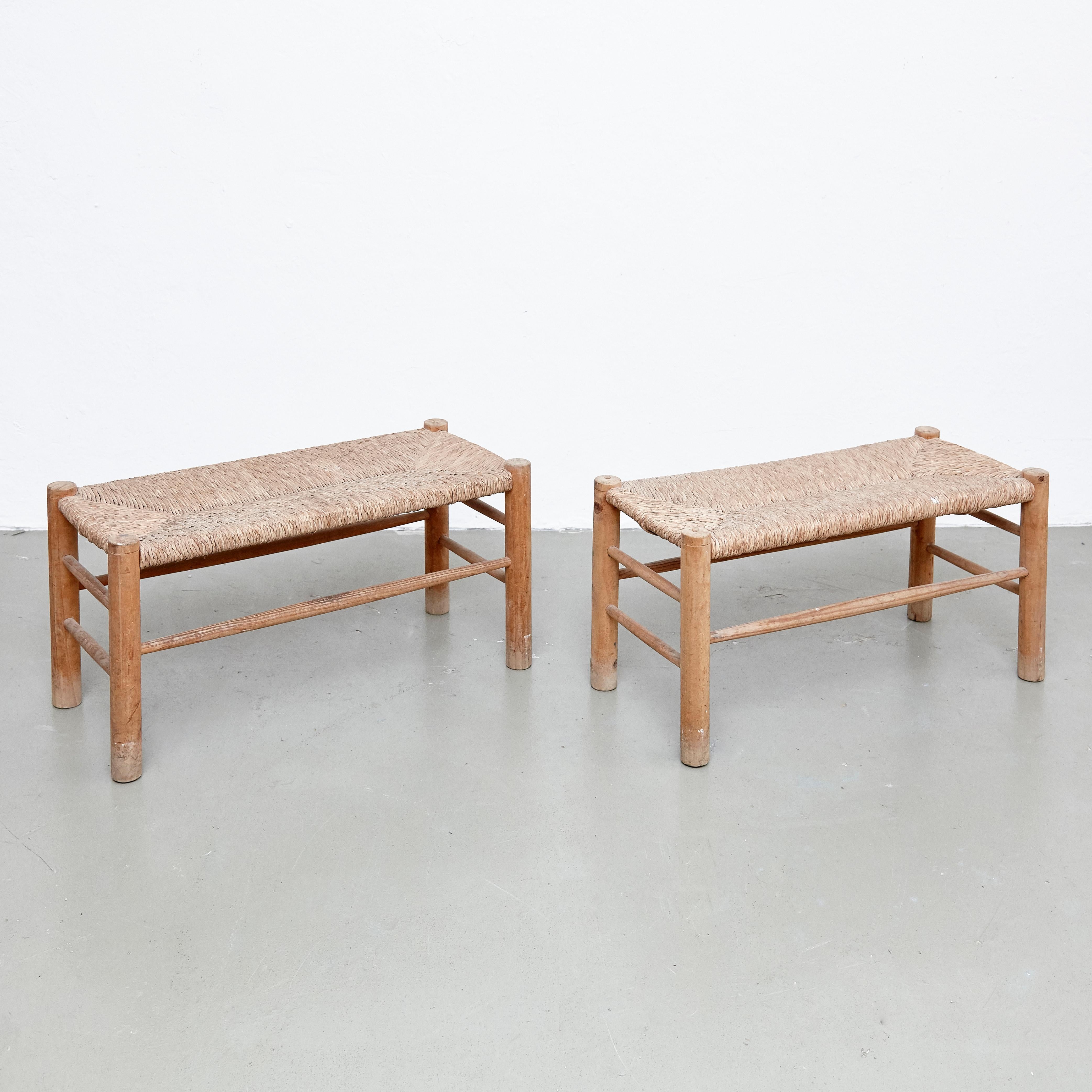 Bench designed in the style of Charlotte Perriand, made by unknown manufacturer. 

Wood and rattan. 

In good original condition, with minor wear consistent with age and use, preserving a beautiful patina. 

Charlotte Perriand (1903-1999) she
