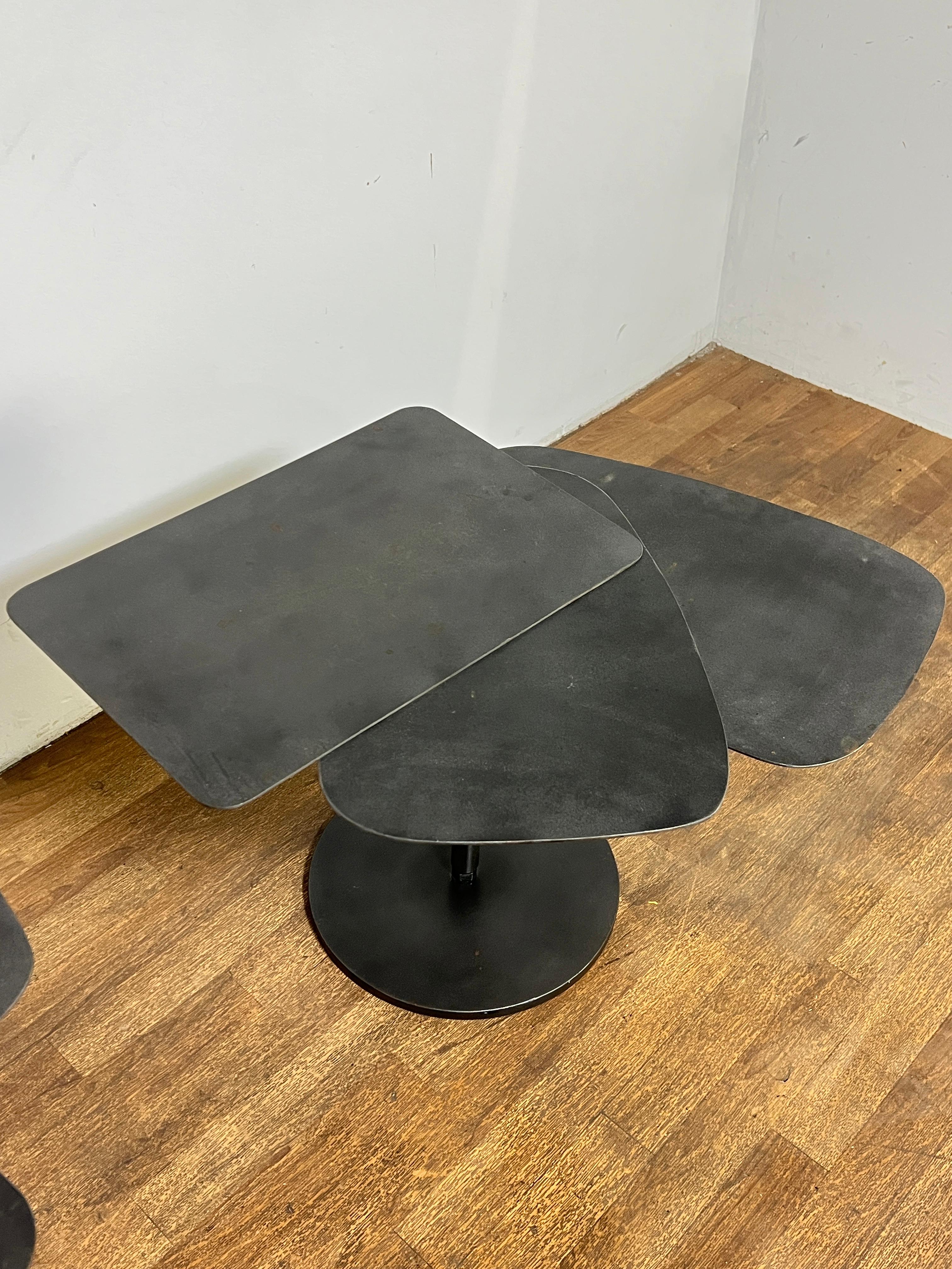A pair of bench made steel fan tables in the manner of the French Constructivist Architect Pierre Chareau. His extraordinary design work from the 1920s and 30s, which often utilized ordinary construction materials such as steel, glass, and concrete,