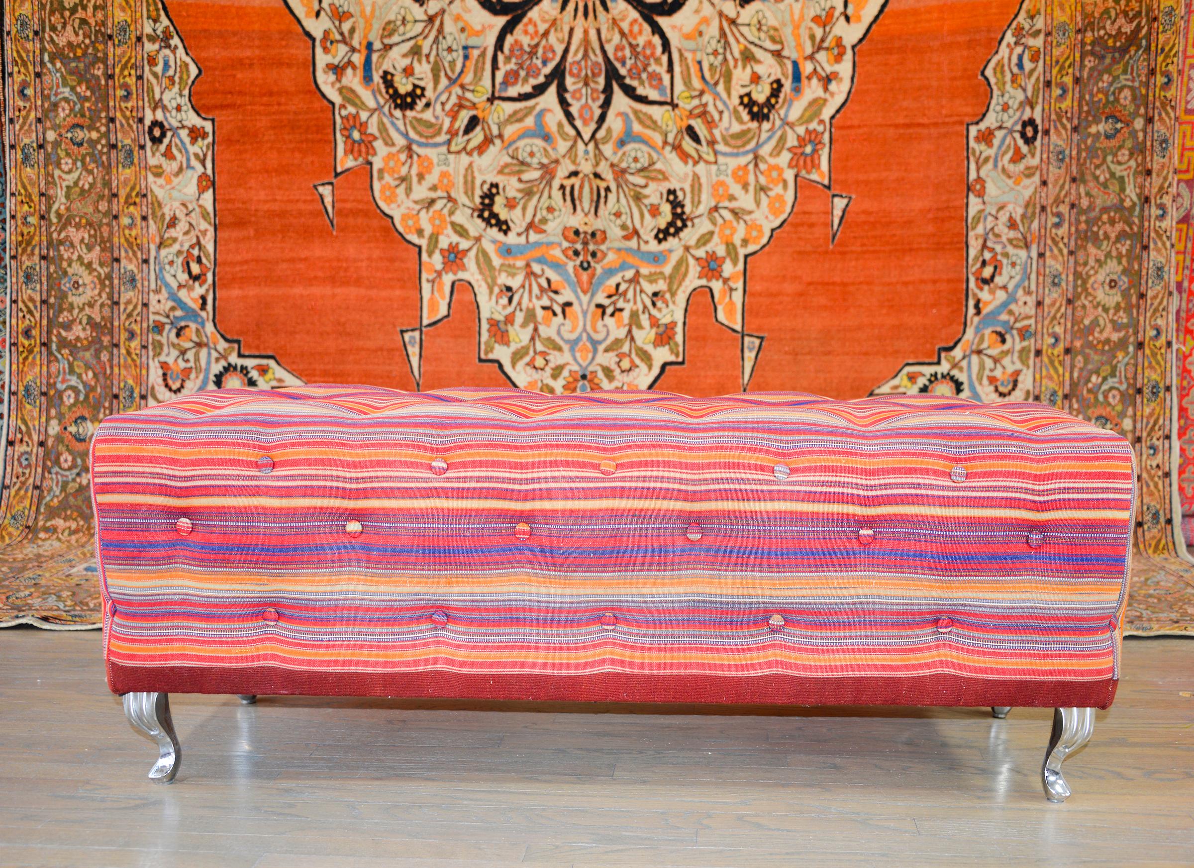 A wonderful pair of 21st century benches or ottomans constructed from vintage Persian Jajim kilim rugs, button tufted on all sides, and raised on small stainless steel cabriole legs.