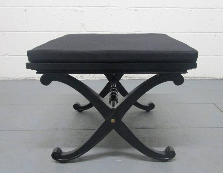 Pair of benches in the manner of Maison Jansen. Has a removable cushioned seat. The benches are black with brass accents.