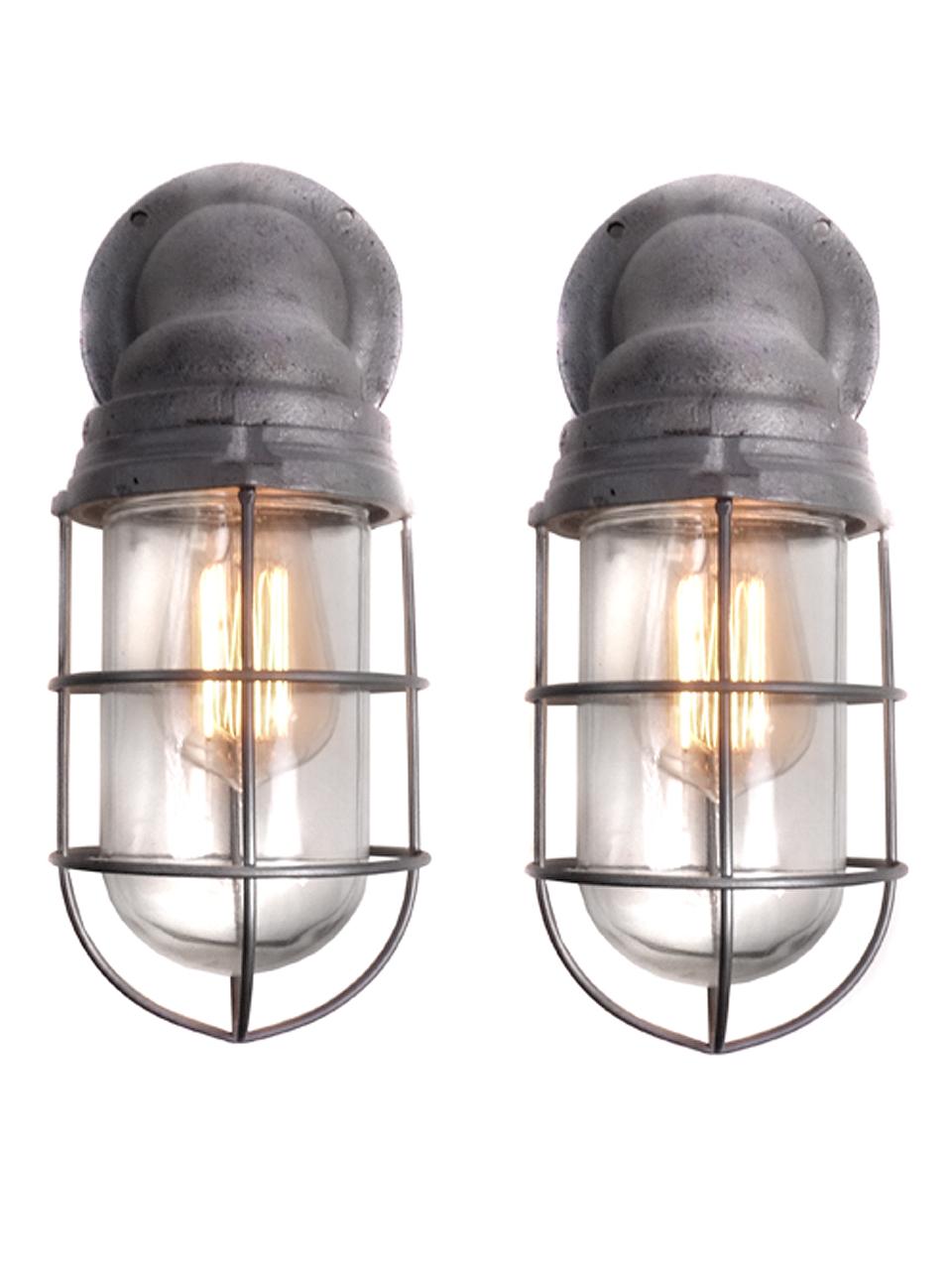 These are a nice matching pair of heavy cast Benjamin explosion proof sconces.
They are original and complete with the screw in glass shade and outer cage.