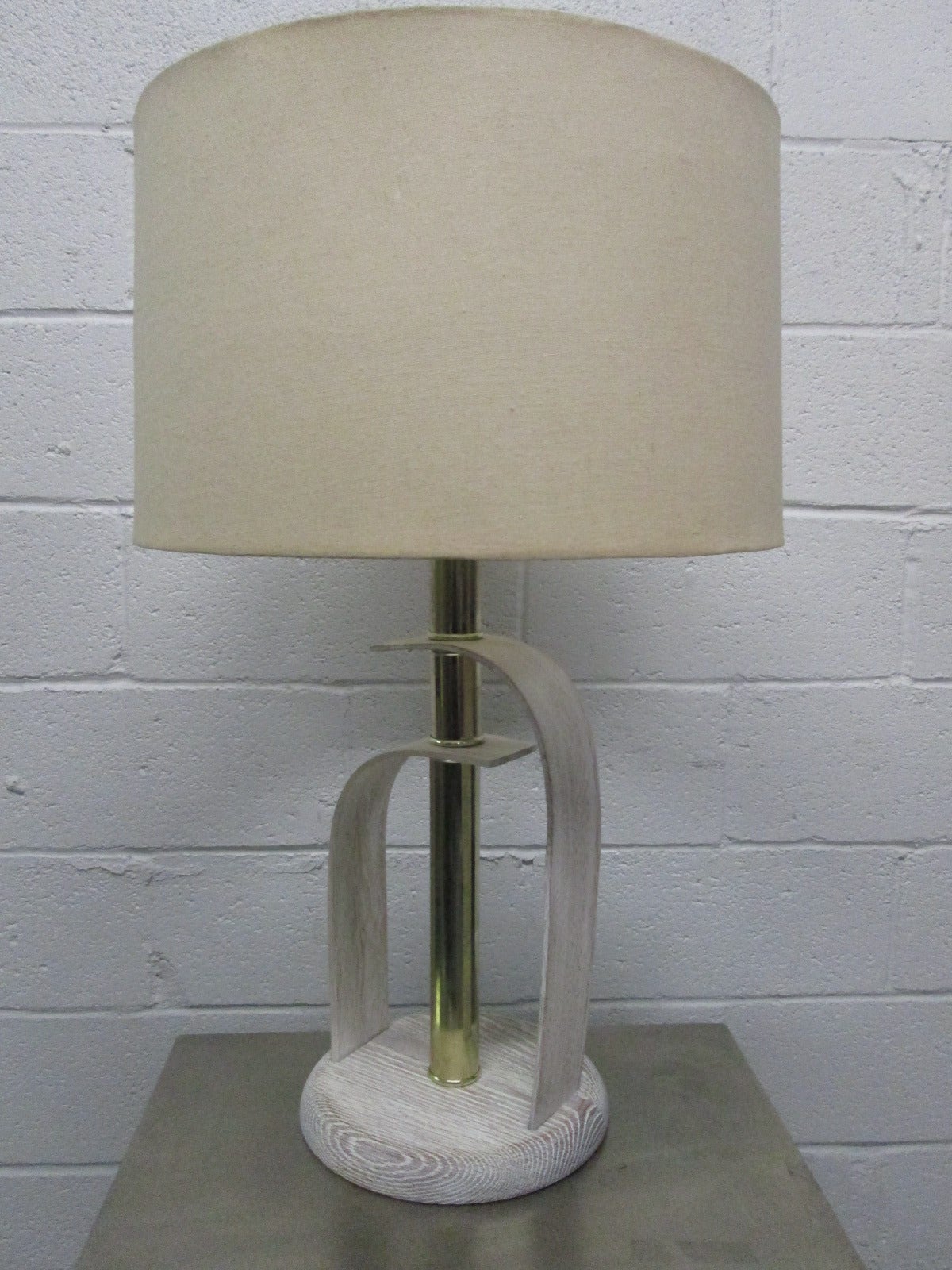 Pair of bentwood Cerused oak lamps. The brass is supported by Cerused bentwood oak.
Measures: 29.5 H. Base is 9.5 in diameter. Under bulb is 19 H.
Shades not included.