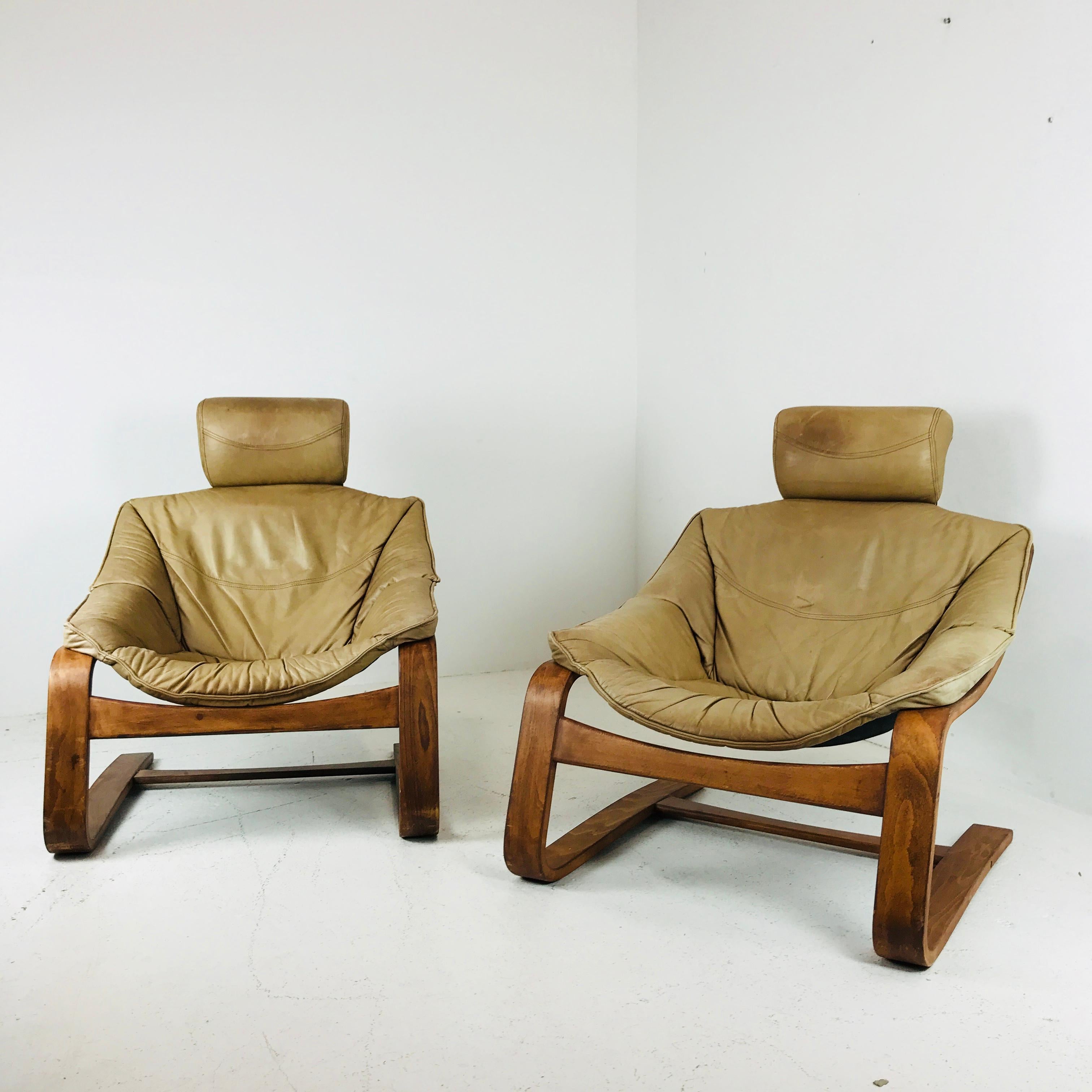 Pair of comfortable bentwood and leather cantilever lounge chairs. These chairs do show signs of wear due to age and use and leather upholstery has a worn and aged patina. This set has a Danish boho chic vibe.

Dimensions:
29