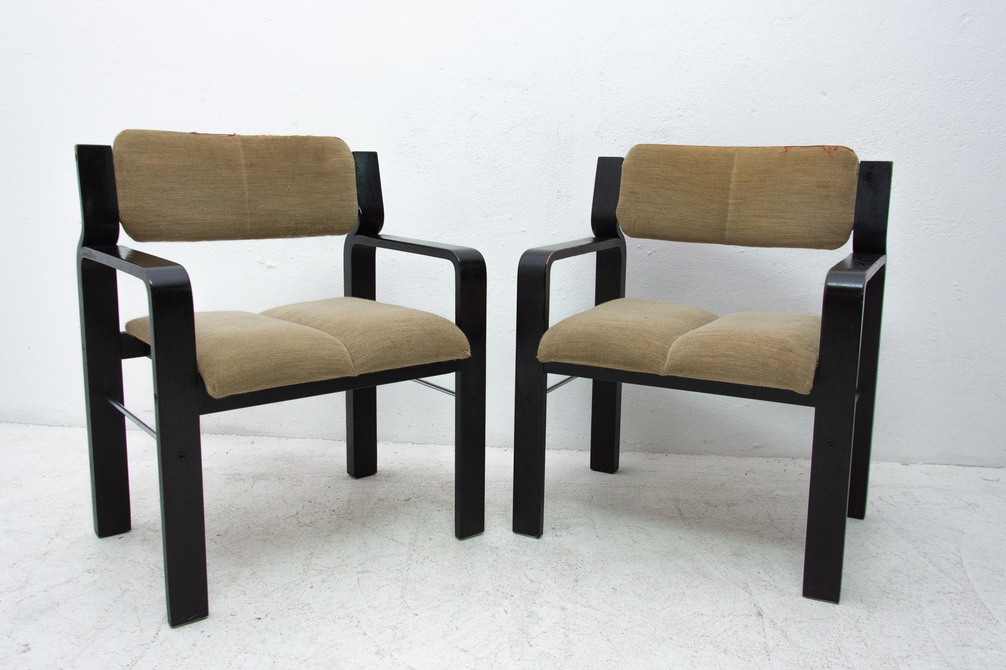 These armchairs were designed by Ludvík Volák for Drevopodnik Holešov. It was made in the former Czechoslovakia in the 1980s. The chairs have an upholstered seats and construction is made of bent dark stained beech wood. Overall, they are in well