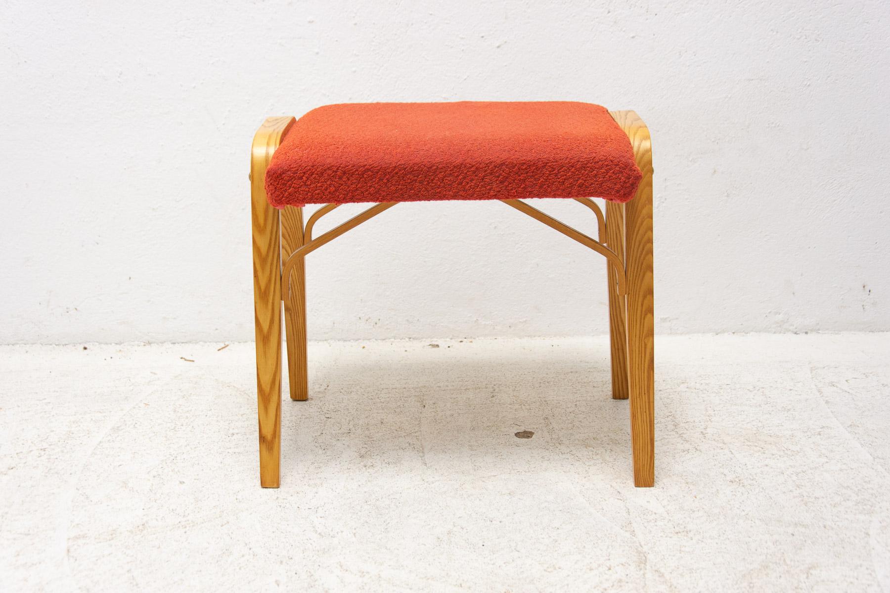 This stool was made by Drevopodnik Holešov in the 1970´s. 
It was made in the former Czechoslovakia.
It has an upholstered seat and structure is made of bent plywood. 
The wood was fully refurbished. The fabric is original.
In very good