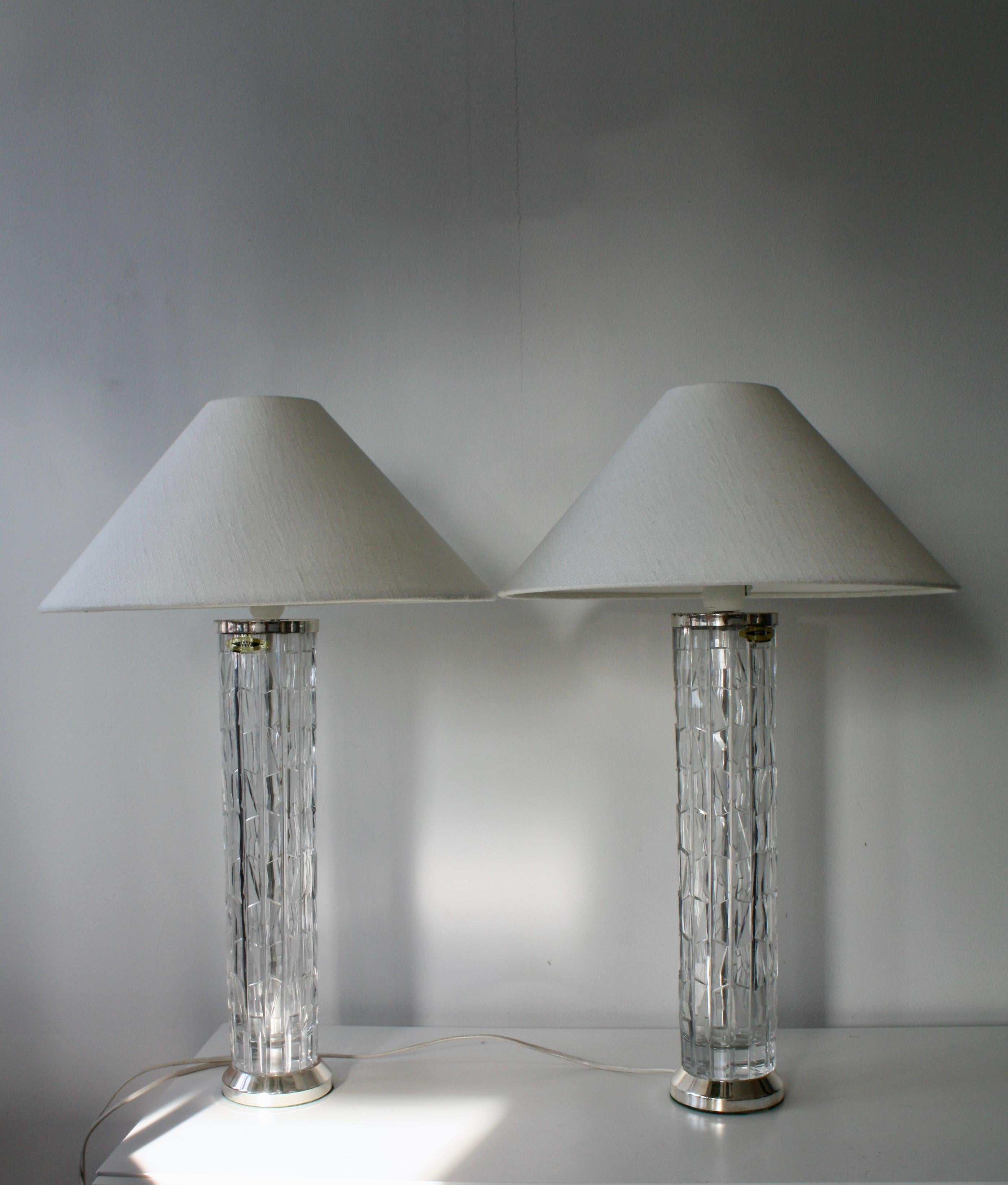 An elegant pair of mid-century table lamps by Bergboms, Sweden, crafted in the 1960s. Their tall, textured glass columns catch and refract the light with jewel-like brilliance, while the refined metal details underscore the timeless sophistication