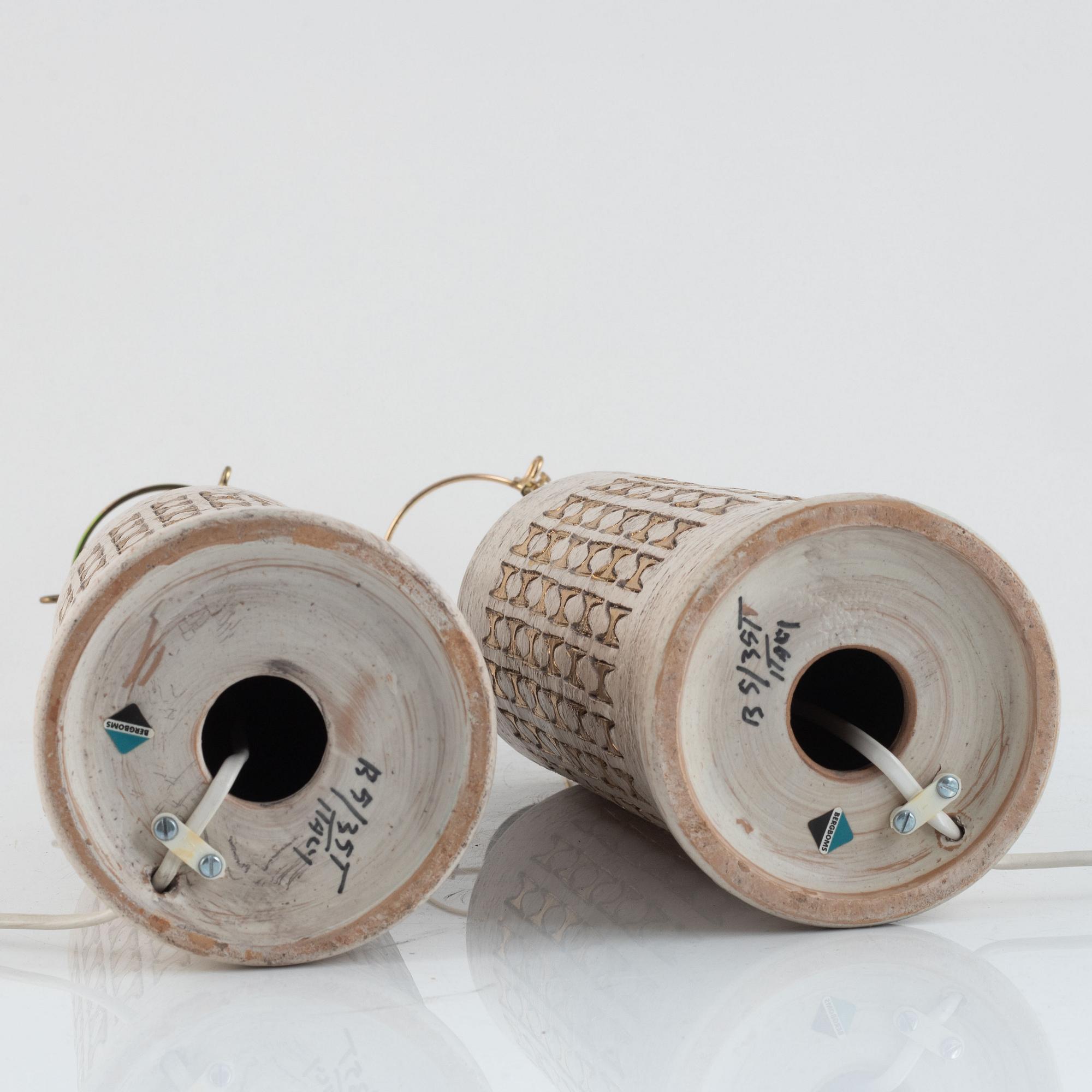 Pair of large Bergboms ivory and gold glazed ceramic table lamps, produced by Bitossi for Bergboms.  They are signed and original labels are present and have a beautiful rich gilded shine when lightened
 Made in ceramics with gold decoration. Total