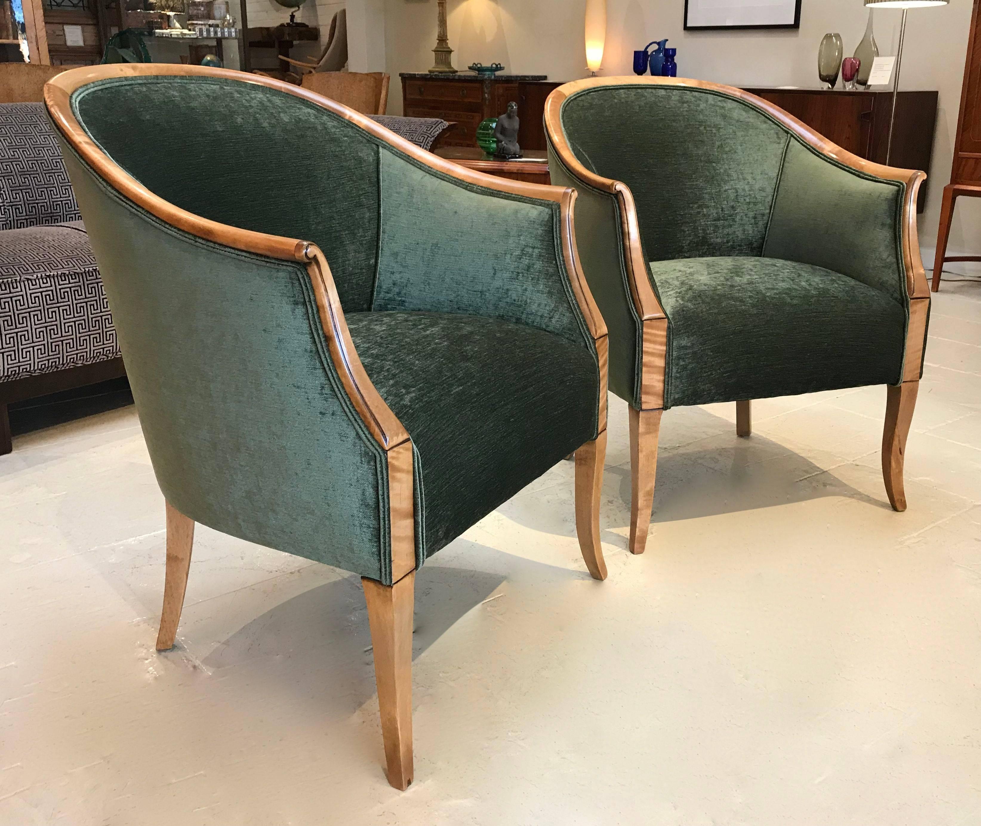 Pair of Swedish flame Birch curved back armchairs. These chairs are beautifully proportioned and visually very pleasing. Re upholstered in a striking emerald green chenille fabric. These chairs are fully sprung in the seats and extremely comfortable