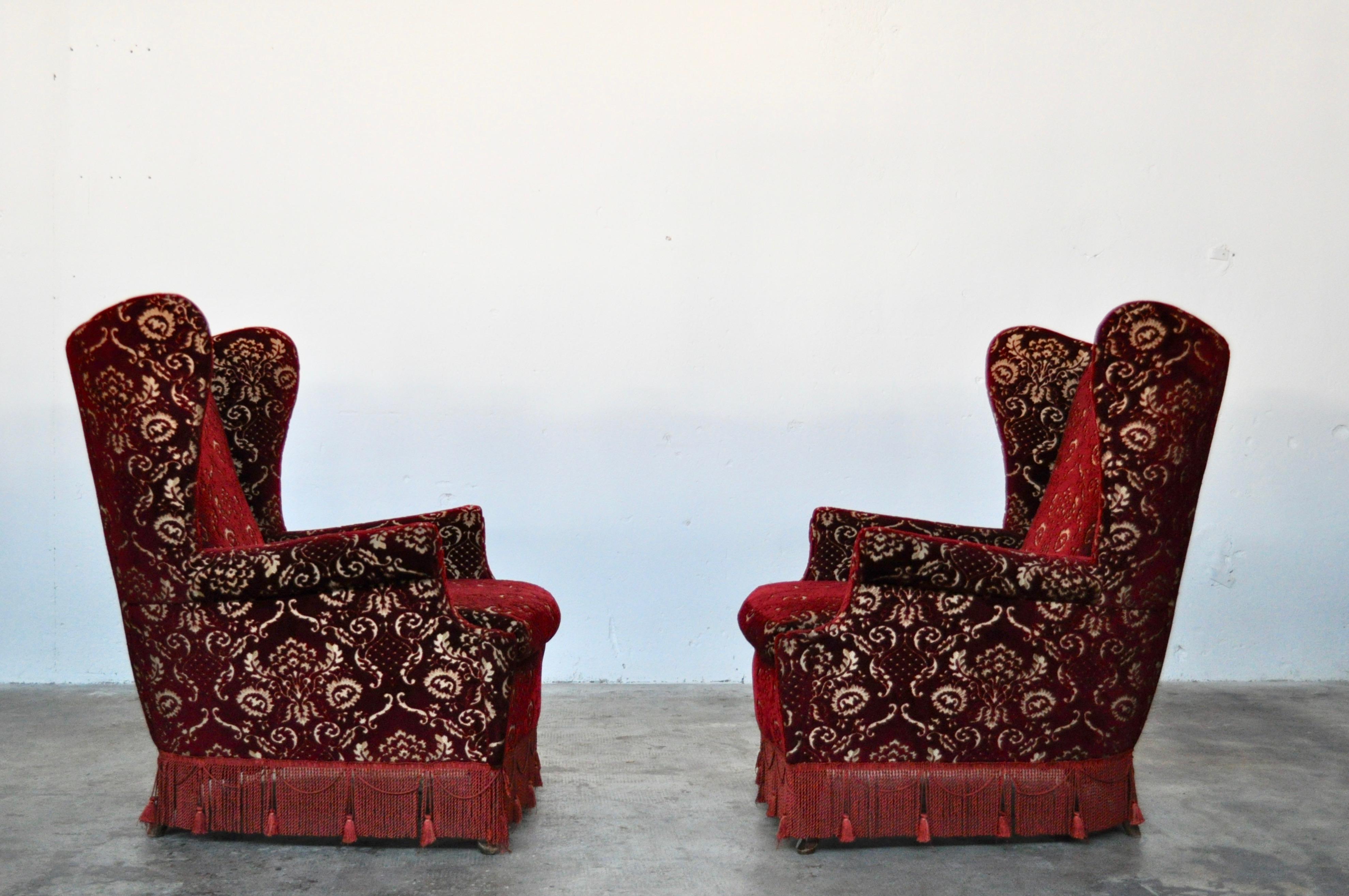 Pair of bergere armchairs in damask velvet and fringes, Italy, 1950. Red velvet, walnut wood feets. Perfect conditions and comfortable seat.
  
