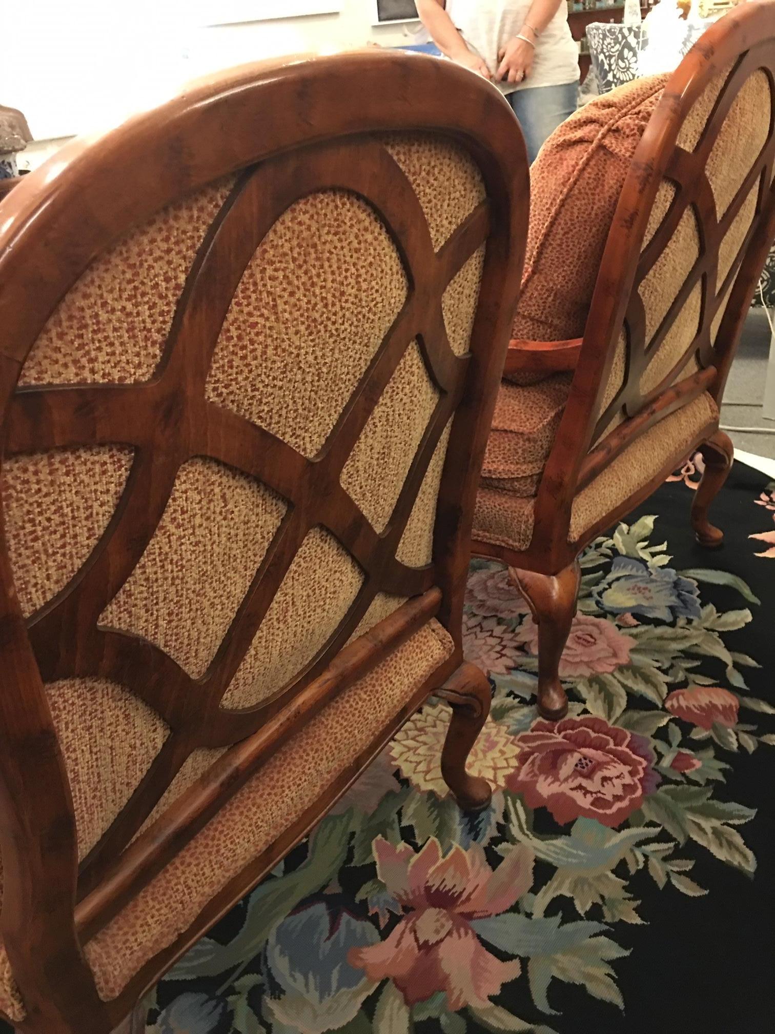 This comfortable pair of chairs has been recently reupholstered in a dappled pumpkin color. Rounded backs with separate cushions, upholstered arms, Queen Anne legs. A special feature of these chairs is the attractive lattice back which makes them