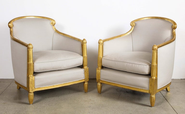 Pair of French Art Deco giltwood bergeres, attributed to Sue et Mare

Each with rounded rectangular padded back flanked by scrolls above sloping arms carved with stylized fluting, on tapering fluted legs.
  