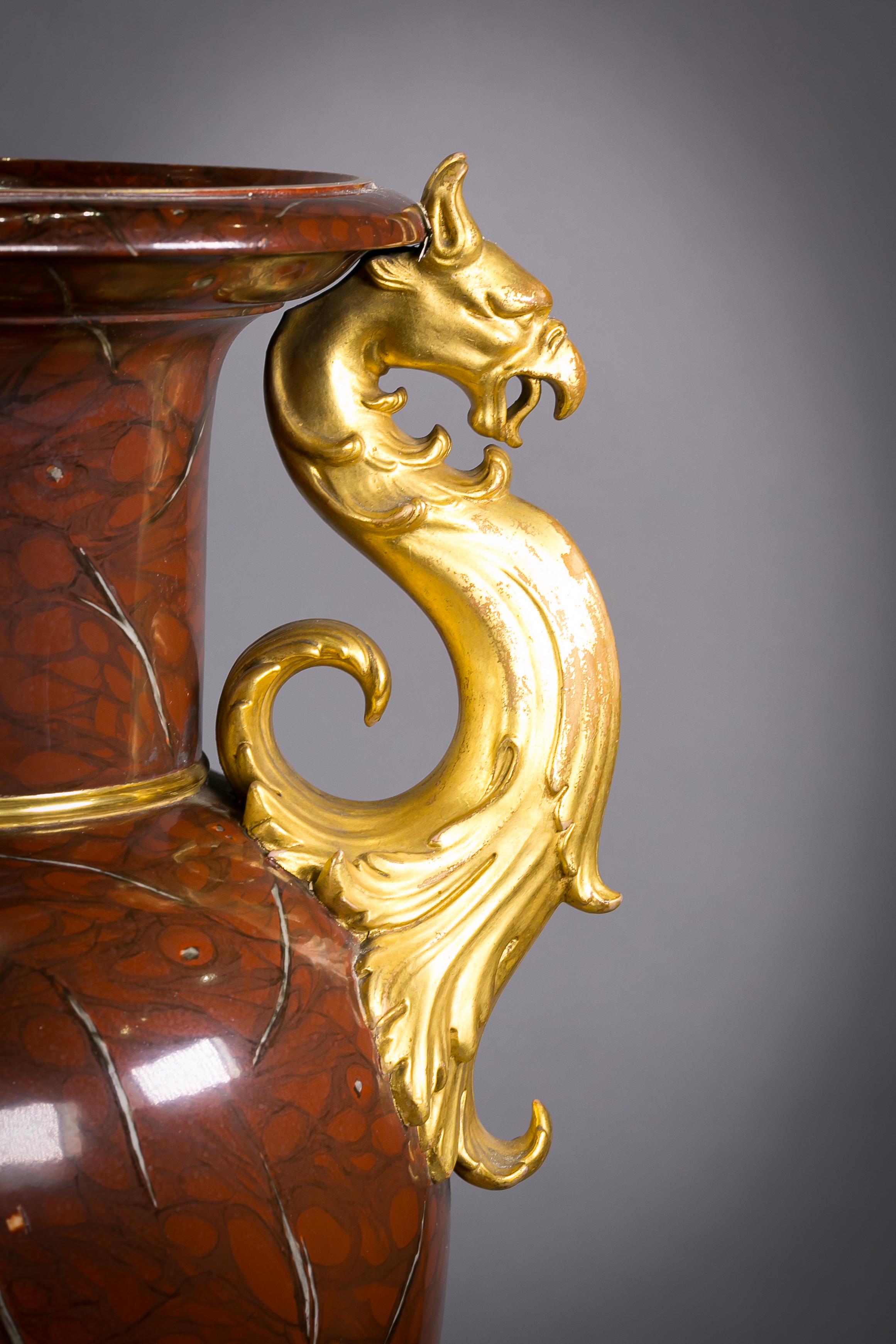 Pair of berlin porcelain faux marble and gilt urns, circa 1825.