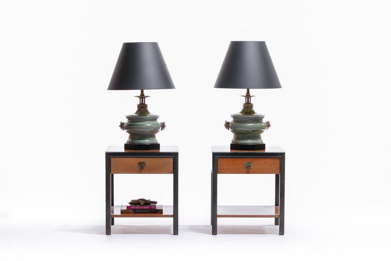 Pair of midcentury nightstands by Bert England for Johnson Furniture Company, circa 1950s. Walnut and ebonized wood frame nightstands / end tables with lower shelf and single drawer with brass toned Asian Modern Pull. Branded with manufacture on