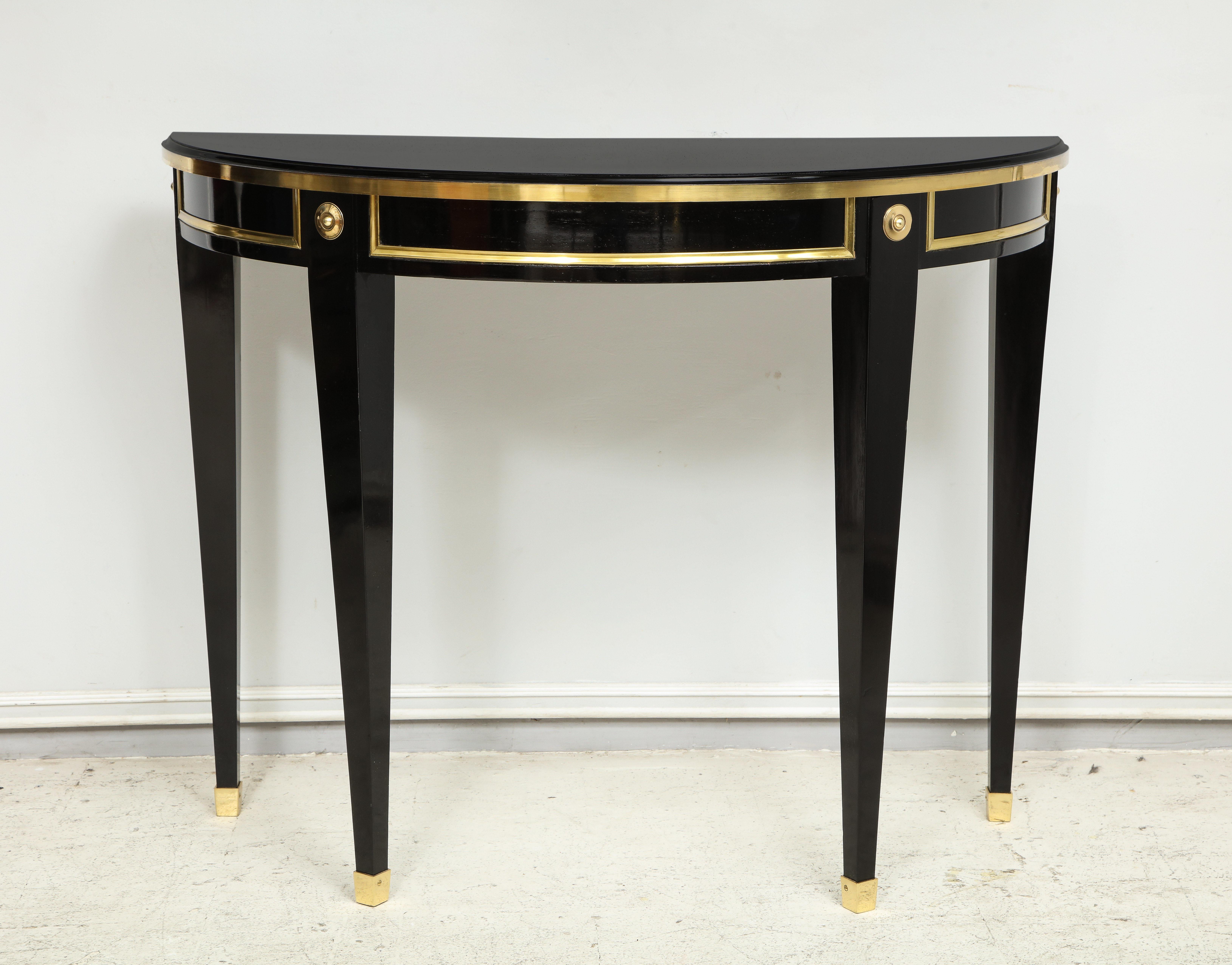 Bespoke pair of ebonized consoles in the neoclassic style with brass banding.
Set fo 2. Please note that these items can be fully customizable with a lead time of 8-10 weeks.
