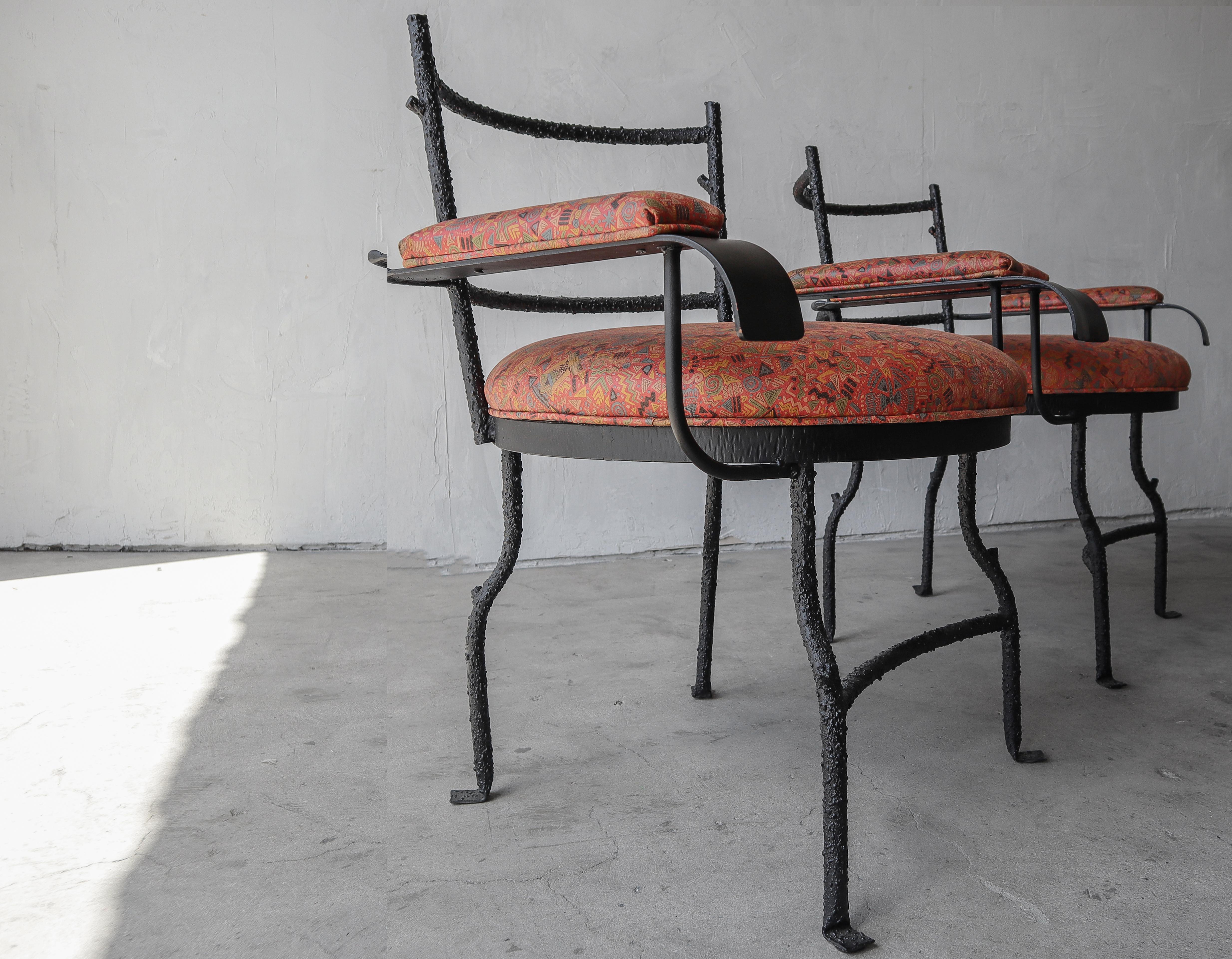 The beauty of this unique, bespoke pair of chairs is truly in the details. Pictures do not do them justice. The black metal frames have textured details giving them the appearance of branches. The arms and seats have been reupholstered with all new