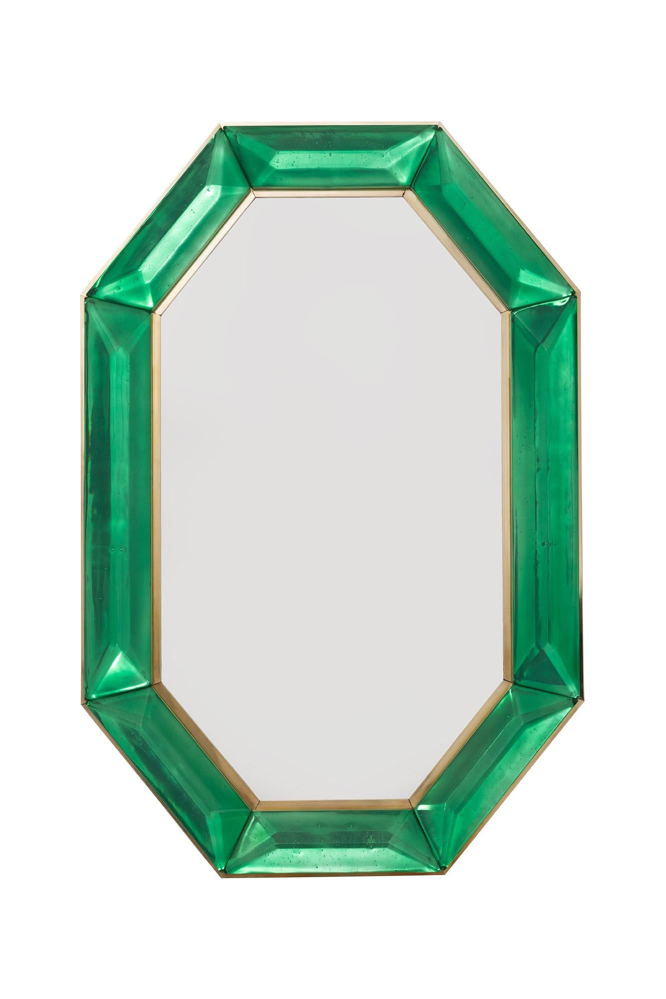 Pair of Bespoke octagon emerald green Murano glass mirrors, in stock
 Vivid and intense emerald green glass block with naturally occurring air inclusions throughout 
 Highly polished faceted pattern
 Brass gallery all around
 Each mirror is a unique