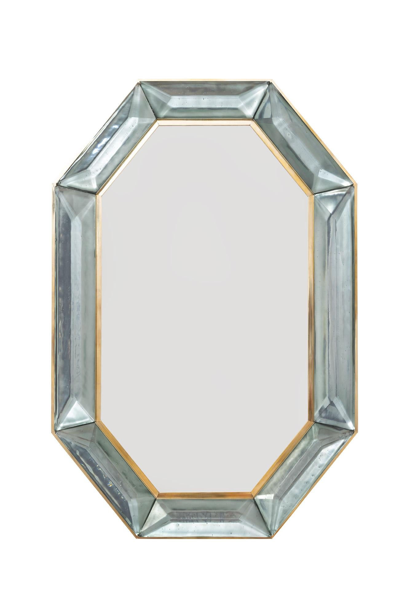 Pair of bespoke octagon sea green Murano glass mirrors, in stock
Vivid and intense sea green glass block with naturally occurring air inclusions throughout
Highly polished faceted pattern
Brass gallery all around
Each mirror is a unique luxury