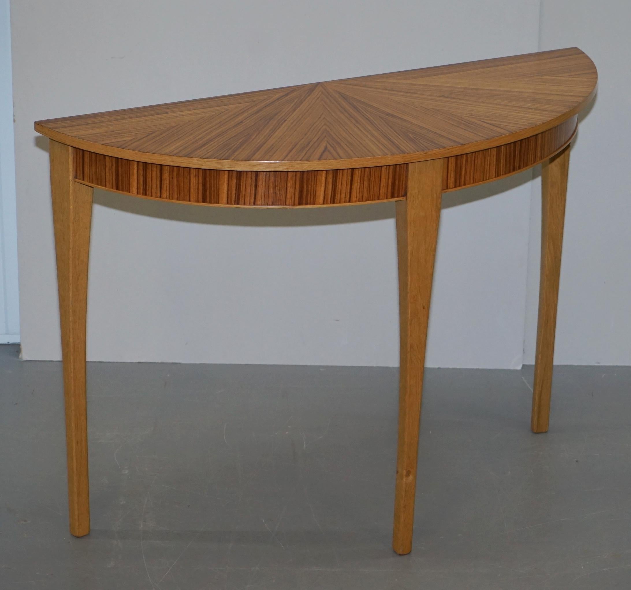 We are delighted to offer for sale this stunning matched pair of new Bevan Funnell Phoenix Zebrano wood demilune console tables

They are new, ex shop display stock, they have some light transport marks around the edges here and there

These are