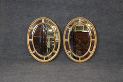 Pair of Beveled Glass Oval Neoclassical Style Gilded Mirrors