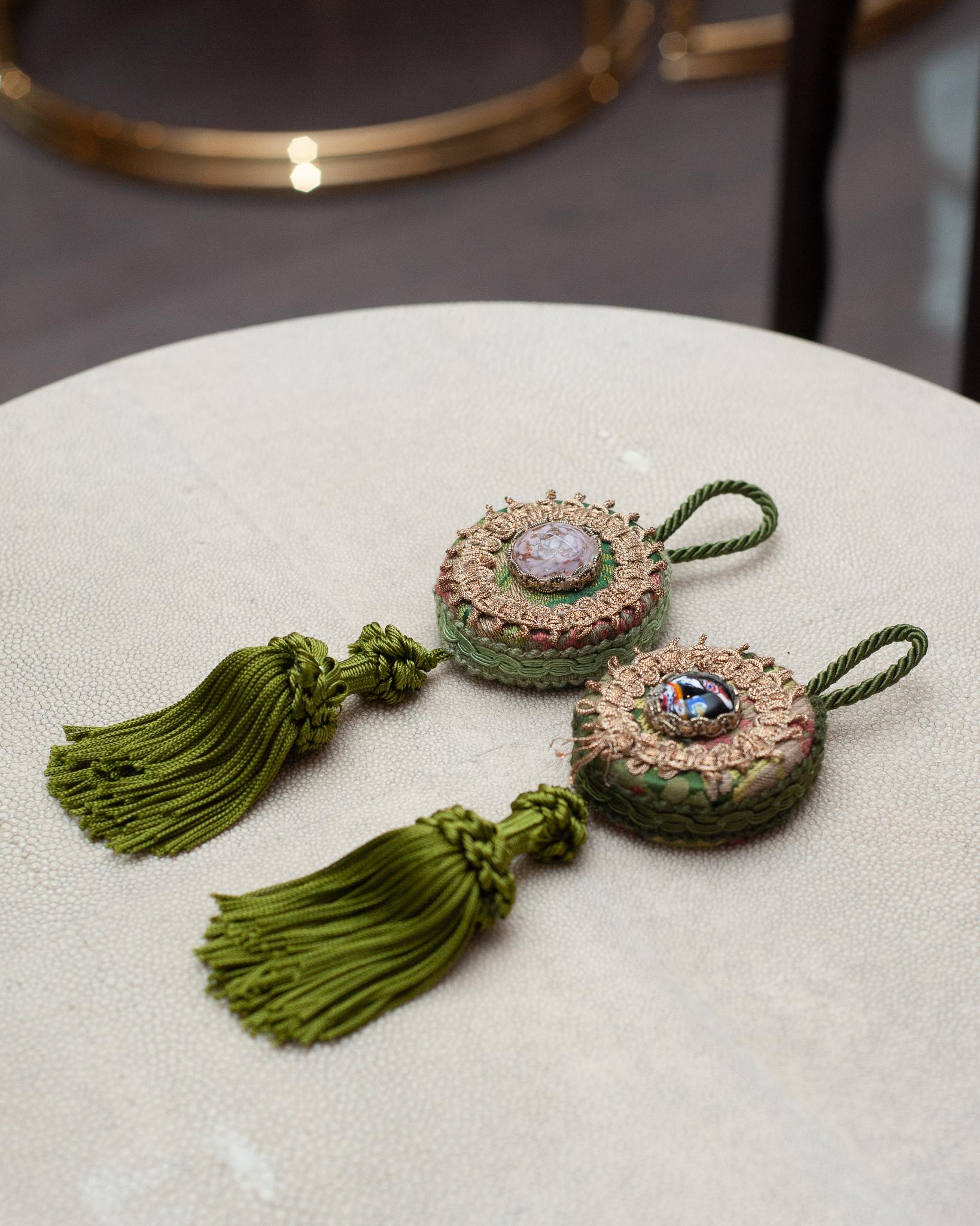 A beautiful pair of green silk fringe and damask tassels, with Murano glass cabochons from Bevilacqua Italy. Established by Luigi Bevilacqua, and operating out of Venice since 1875, Bevilacqua Tessuti produces the most exquisite handwoven fabrics