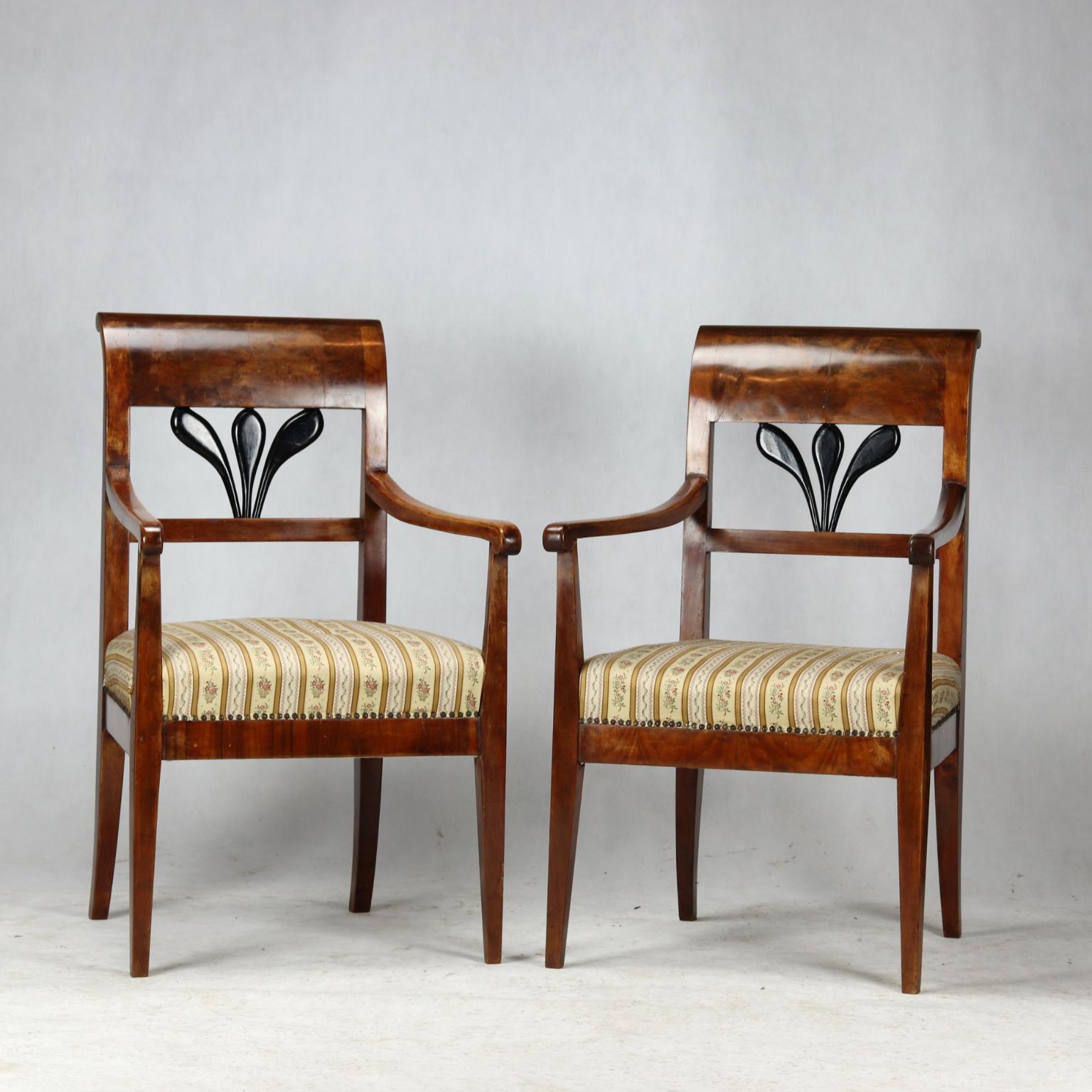 The armchairs dates from the early Biedermeier period at the beginning of the 19th century. The body of the armchairs is made of spruce wood and was covered with a very beautiful thick walnut veneer. The armchairs are in a good condition. The