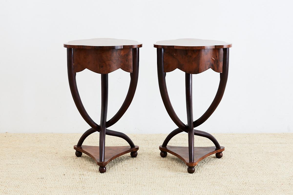 Fantastic pair of Biedermeier burl wood veneer side tables featuring an unusual bent leg design. These Central European tables have a trefoil shaped top with scalloped aprons and triangular bases. Constructed from elm and walnut with clean lines and