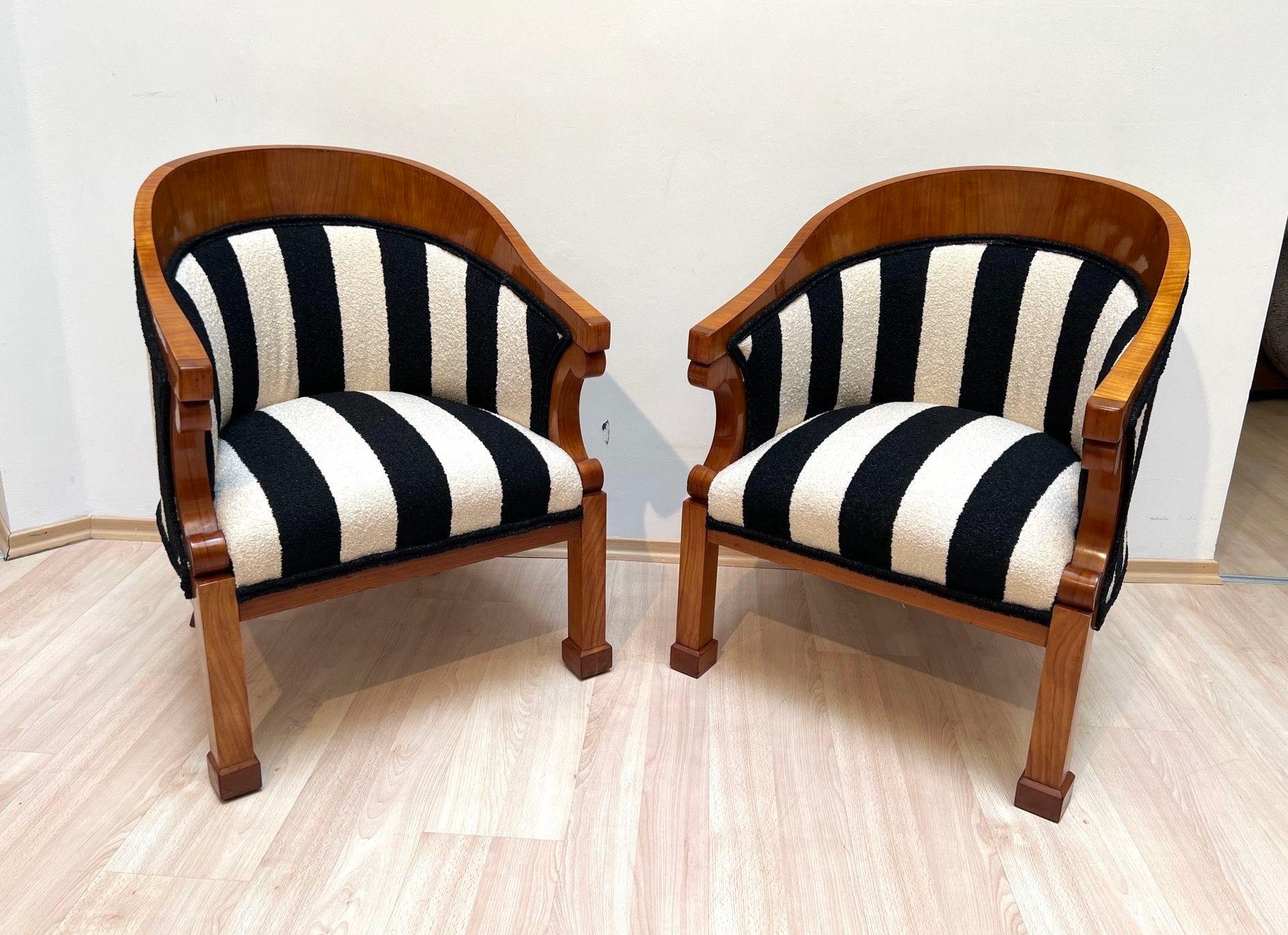 Beautiful pair of original Biedermeier Bergere chairs in cherry wood from Austria around 1830.
Cherry veneer and solid, hand-polished with shellac (french polished). Solid cherry stollen feet. Square tapered conical legs at the back, curved