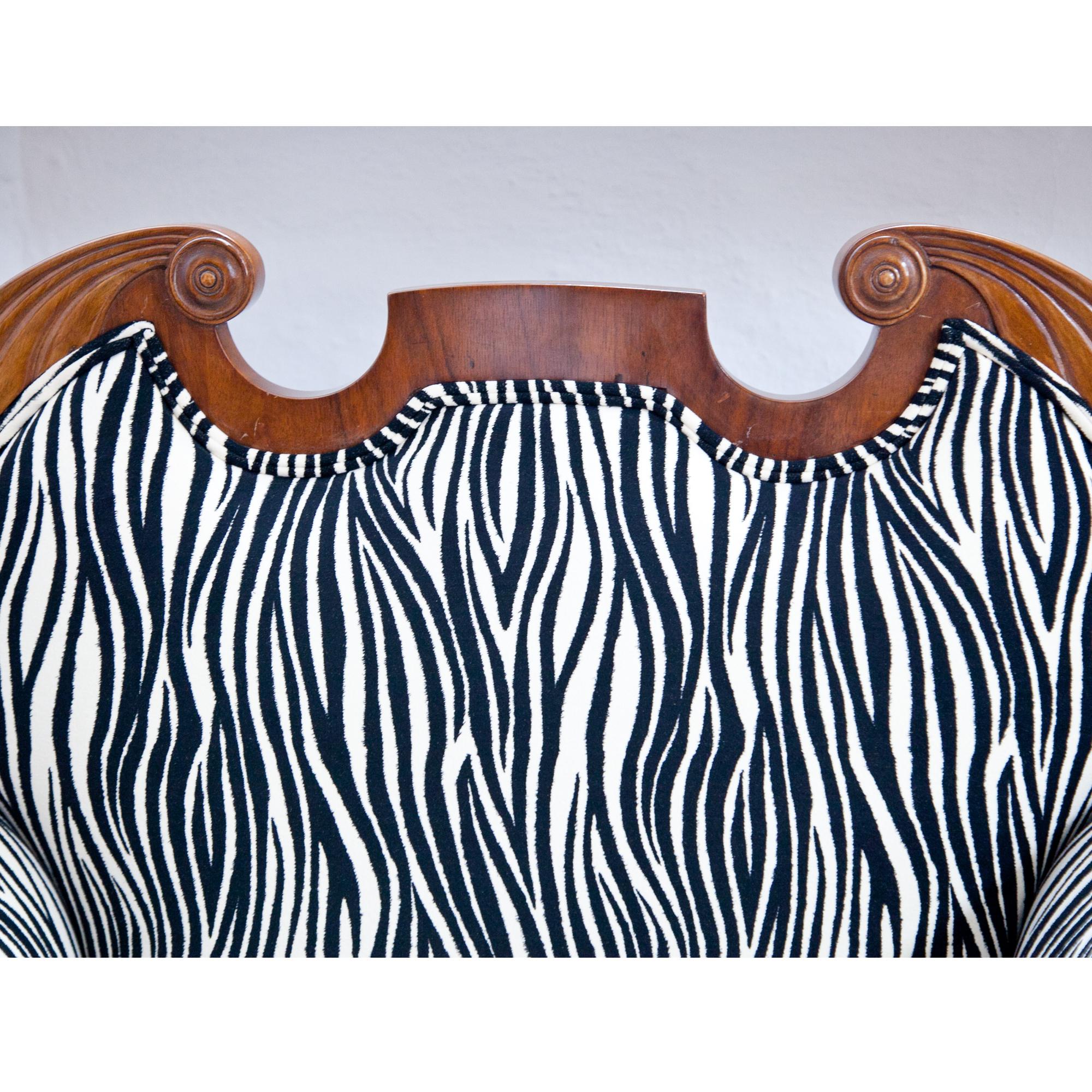 Pair of Biedermeier armchairs, standing on scrolled feet. The armchairs are upholstered with a modern zebra-patterned fabric. The backrests are in the shape of a swan's neck pediment.