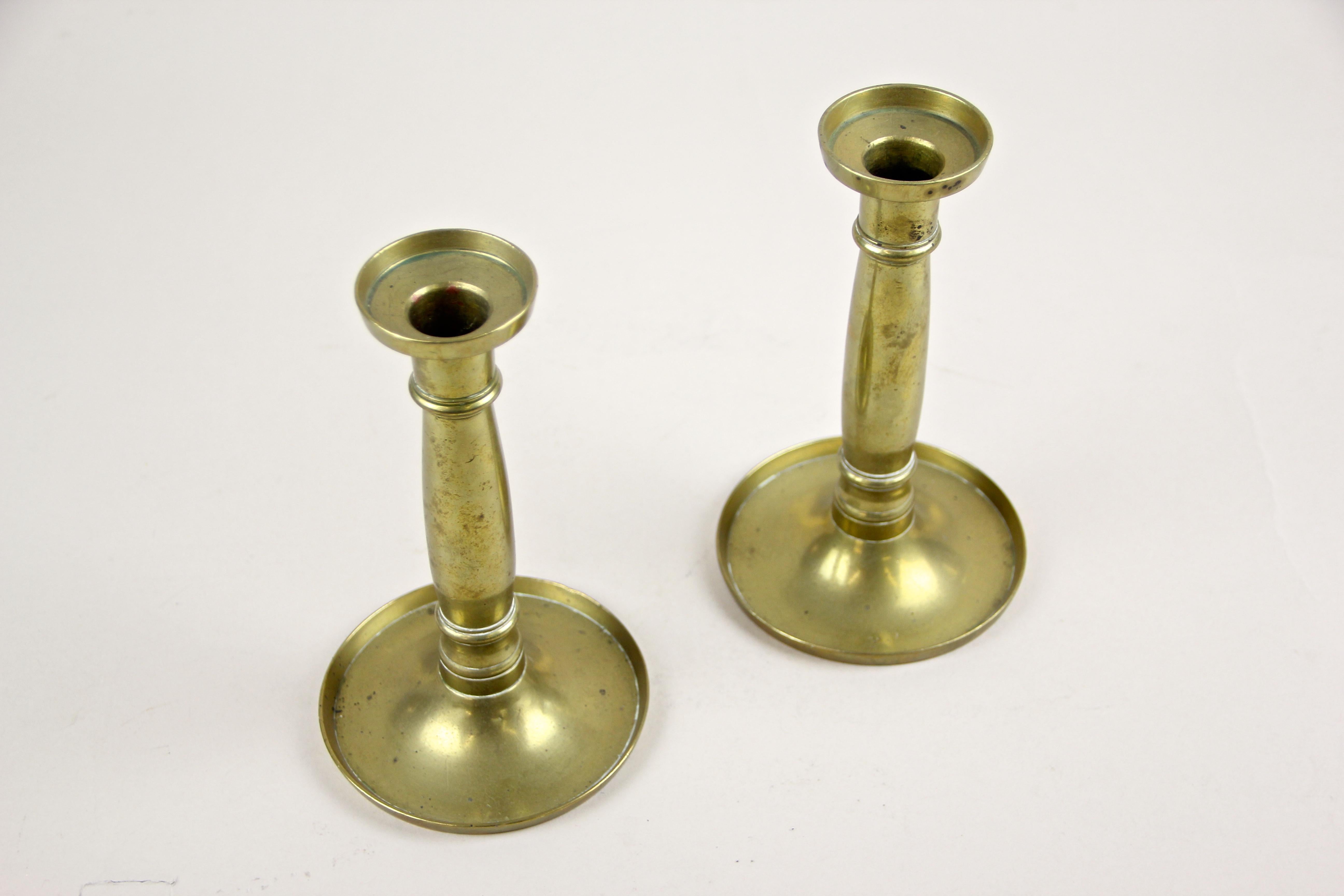 Decorative Pair Of Biedermeier Brass Candlesticks out of Austria around 1830. A straight, clear shape - a typical attribute for the early Bidermeier period - processed of fine brass, makes this pair of antique candlesticks very decorative and