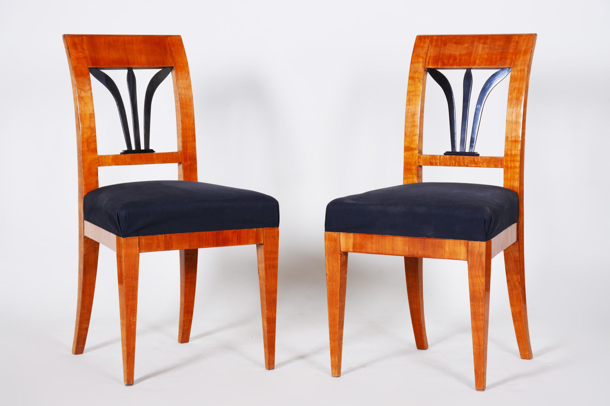 Pair of Biedermeier dining chairs made in Czechia circa 1830s. Restored by our team. Made out of Cherry wood and fabric, very high quality materials.