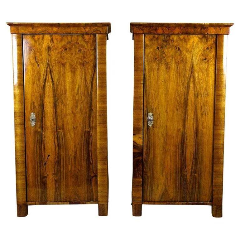Extraordinary pair of very rare nutwood cabinets from the famous Biedermeier period in Austria around 1830. These unique cabinets impress with a straight timeless shape and unique veneered surface. Both front doors were veneered with finest burr